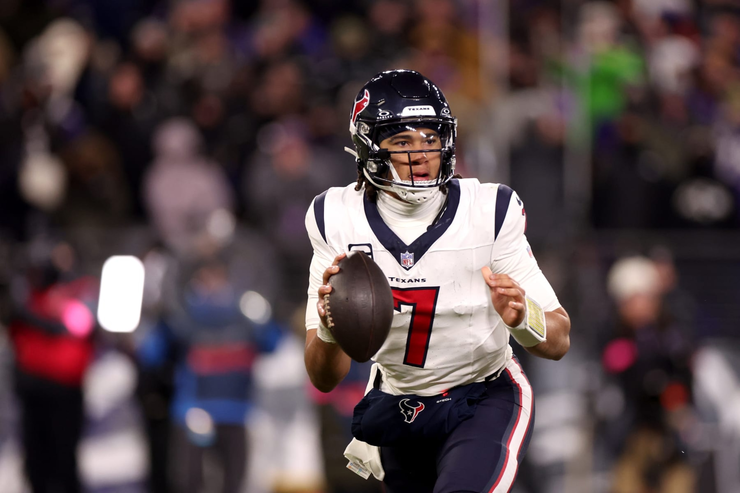 BALTIMORE, MARYLAND - JANUARY 20: Quarterback C.J. Stroud #7 of the Houston Texans rolls out to pass against the Baltimore Ravens in the second half at M&T Bank Stadium on January 20, 2024 in Baltimore, Maryland. (Photo by Rob Carr/Getty Images) BALTIMORE, MARYLAND - JANUARY 20: Quarterback C.J. Stroud #7 of the Houston Texans rolls out to pass against the Baltimore Ravens in the second half at M&T Bank Stadium on January 20, 2024 in Baltimore, Maryland. (Photo by Rob Carr/Getty Images)