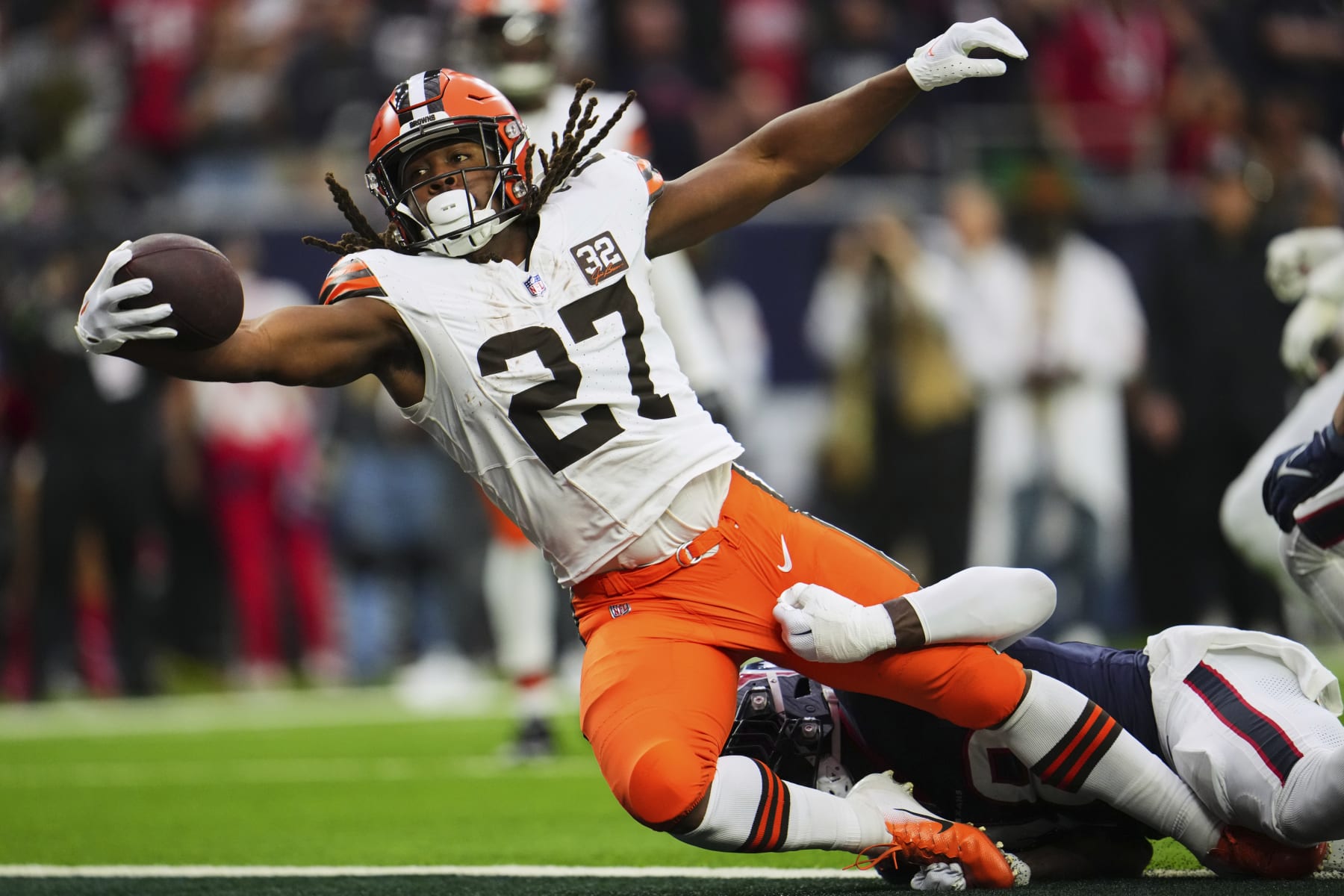 HOUSTON, TX - JANUARY 13: Kareem Hunt #27 of the Cleveland Browns rushes for a touchdown against the Houston Texans during the first half of the AFC Wild Card playoff game at NRG Stadium on January 13, 2024 in Houston, Texas. (Photo by Cooper Neill/Getty Images)
