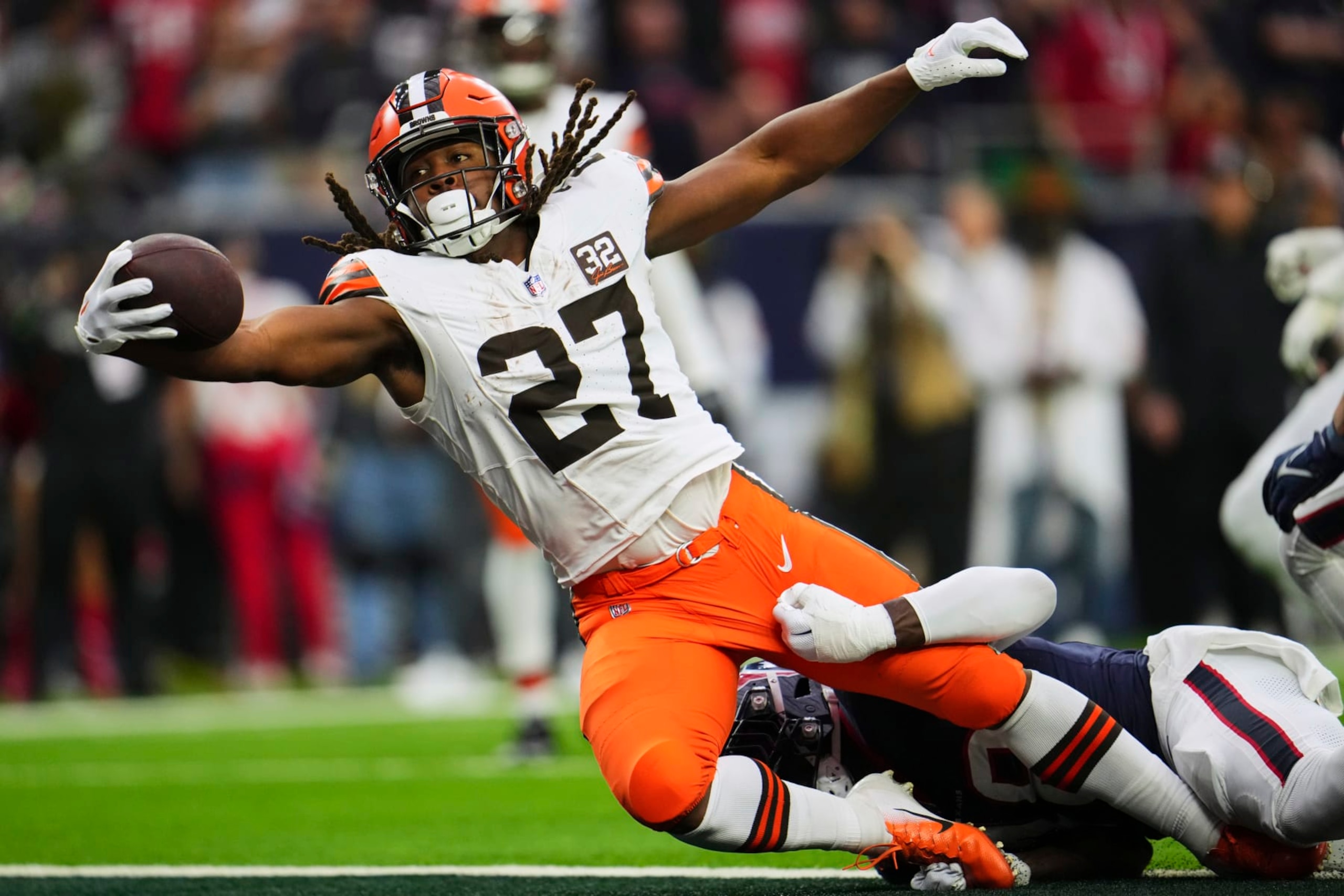HOUSTON, TX - JANUARY 13: Kareem Hunt #27 of the Cleveland Browns rushes for a touchdown against the Houston Texans during the first half of the AFC Wild Card playoff game at NRG Stadium on January 13, 2024 in Houston, Texas. (Photo by Cooper Neill/Getty Images)