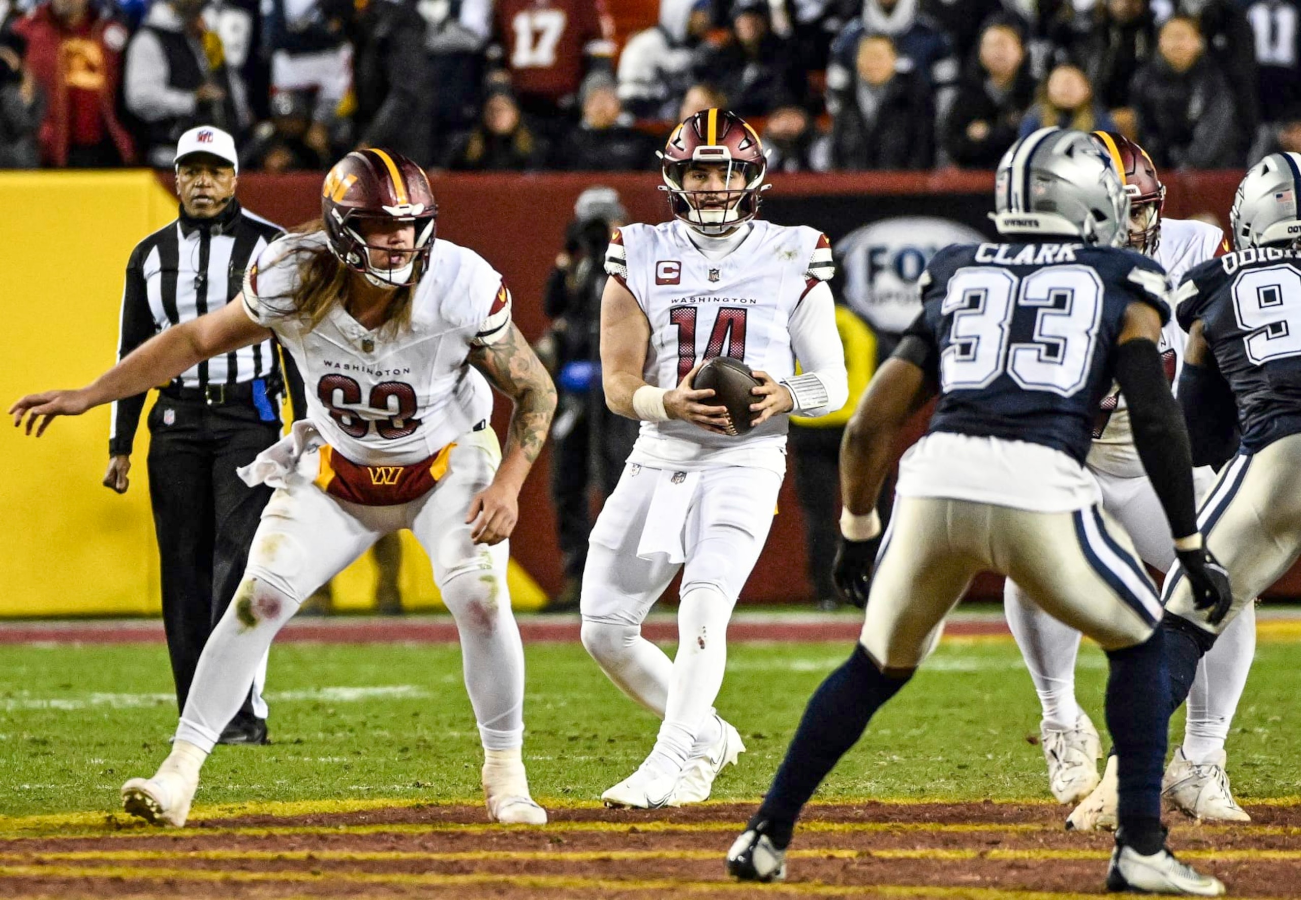 LANDOVER, MD - JANUARY 07: Washington Commanders quarterback Sam Howell (14) drops back with center Nick Gates (63) providing protection during the NFL game between the Dallas Cowboys and the Washington Commanders on January 7, 2024 at FedEx Field in Landover, MD. (Photo by Mark Goldman/Icon Sportswire via Getty Images) LANDOVER, MD - JANUARY 07: Washington Commanders quarterback Sam Howell (14) drops back with center Nick Gates (63) providing protection during the NFL game between the Dallas Cowboys and the Washington Commanders on January 7, 2024 at FedEx Field in Landover, MD. (Photo by Mark Goldman/Icon Sportswire via Getty Images)