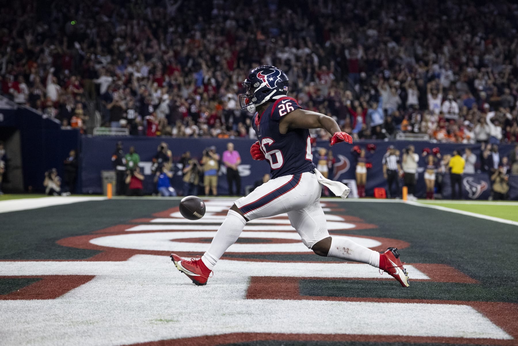 HOUSTON, TEXAS - JANUARY 13: Devin Singletary #26 of the Houston Texans celebrates after running for a touchdown during an NFL wild-card playoff football game between the Houston Texans and the Cleveland Browns at NRG Stadium on January 13, 2024 in Houston, Texas. (Photo by Michael Owens/Getty Images)