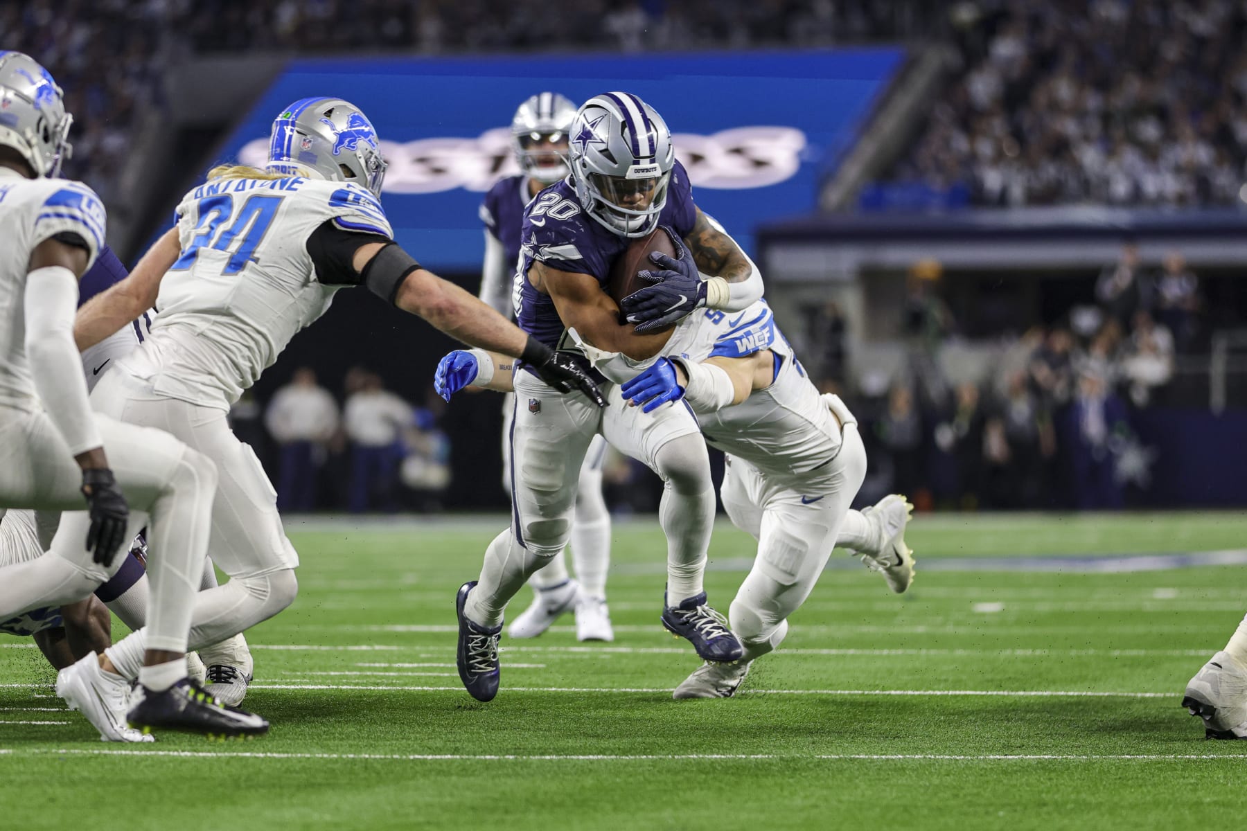 ARLINGTON, TX - DECEMBER 30: Dallas Cowboys running back Tony Pollard (20) runs through the line of scrimmage as Detroit Lions defensive end Aidan Hutchinson (97) tries to tackle him during the game between the Dallas Cowboys and the Detroit Lions on December 30, 2023 at AT&T Stadium in Arlington, Texas. (Photo by Matthew Pearce/Icon Sportswire via Getty Images)