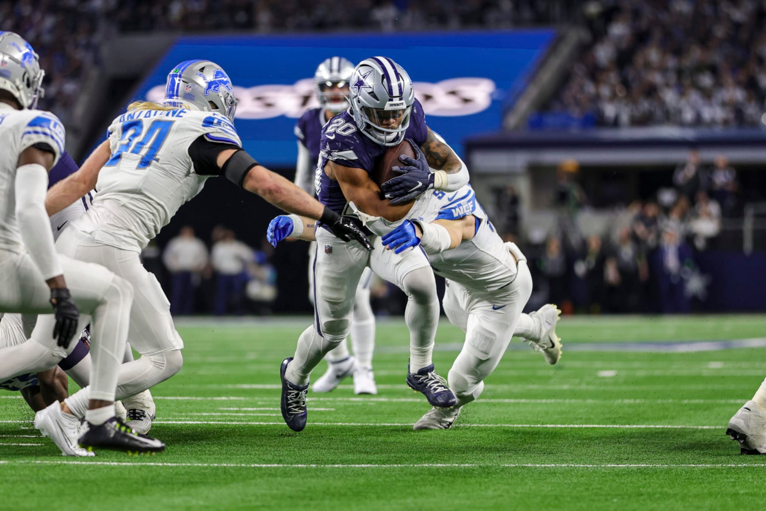 ARLINGTON, TX - DECEMBER 30: Dallas Cowboys running back Tony Pollard (20) runs through the line of scrimmage as Detroit Lions defensive end Aidan Hutchinson (97) tries to tackle him during the game between the Dallas Cowboys and the Detroit Lions on December 30, 2023 at AT&T Stadium in Arlington, Texas. (Photo by Matthew Pearce/Icon Sportswire via Getty Images)