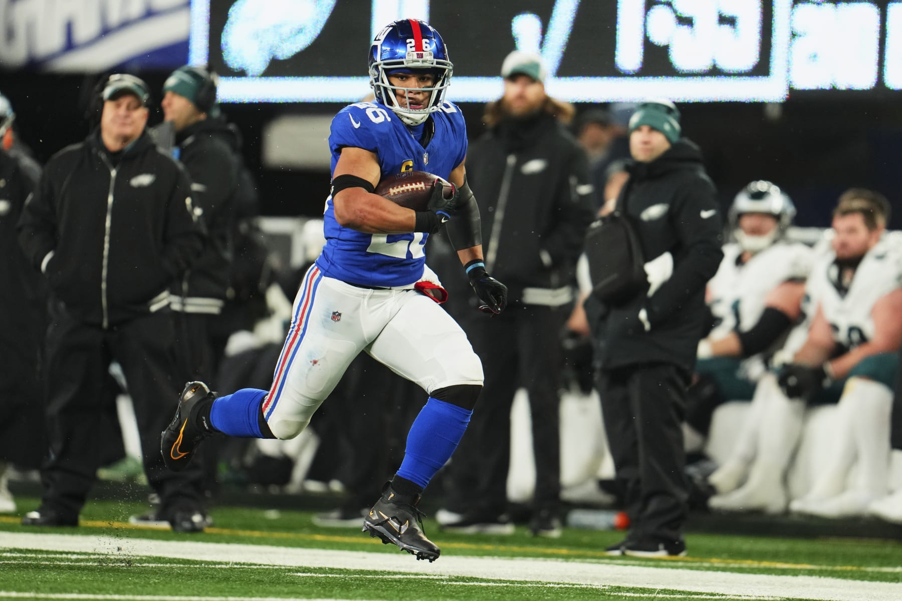 EAST RUTHERFORD, NJ - JANUARY 07: Saquon Barkley #26 of the New York Giants runs with the ball against the Philadelphia Eagles during the first half at MetLife Stadium on January 7, 2024 in East Rutherford, New Jersey. (Photo by Cooper Neill/Getty Images)