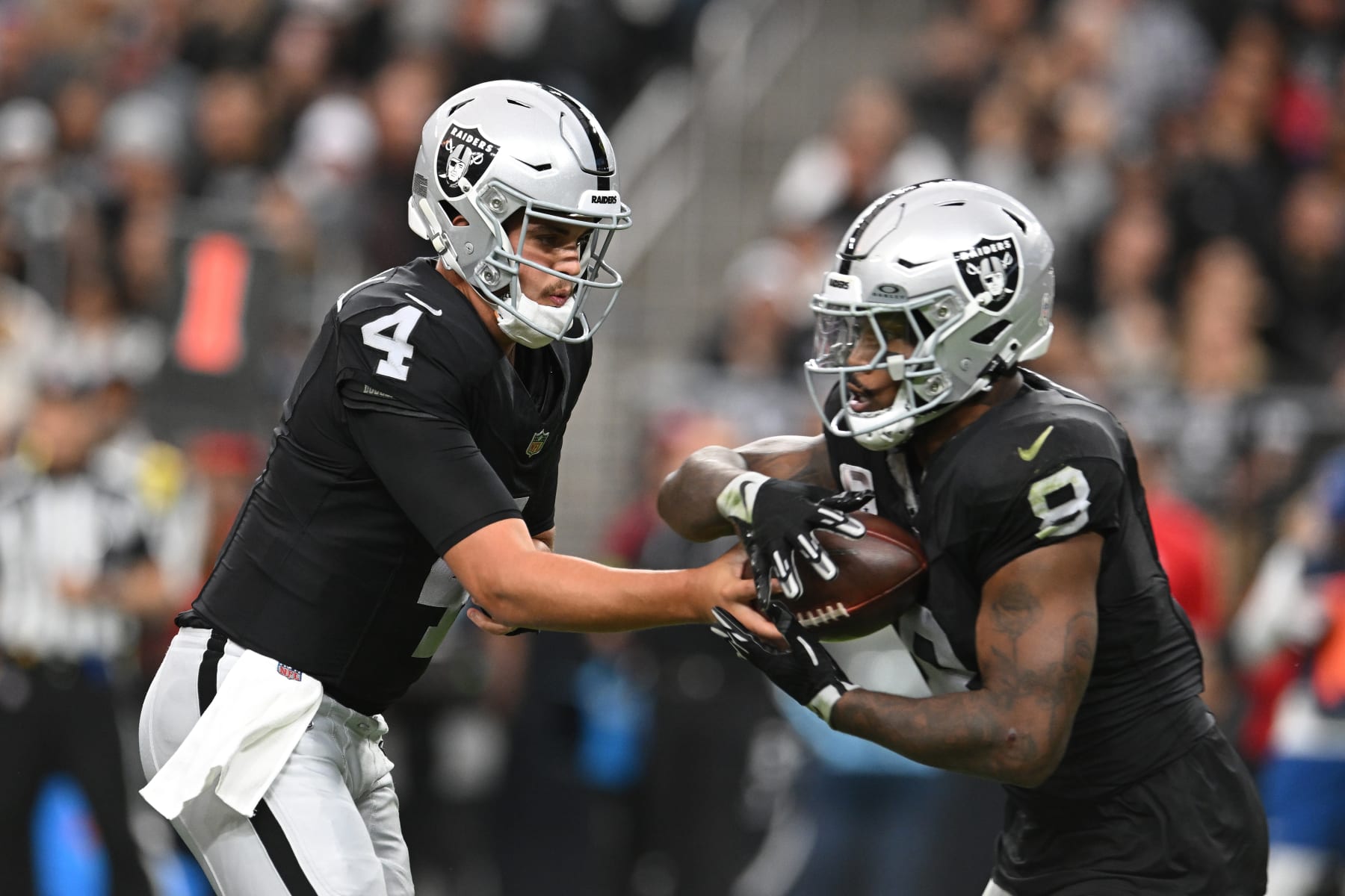 LAS VEGAS, NEVADA - NOVEMBER 26: Aidan O'Connell #4 of the Las Vegas Raiders hands the ball off to Josh Jacobs #8 of the Las Vegas Raiders during the first quarter against the Kansas City Chiefs at Allegiant Stadium on November 26, 2023 in Las Vegas, Nevada. (Photo by Candice Ward/Getty Images)