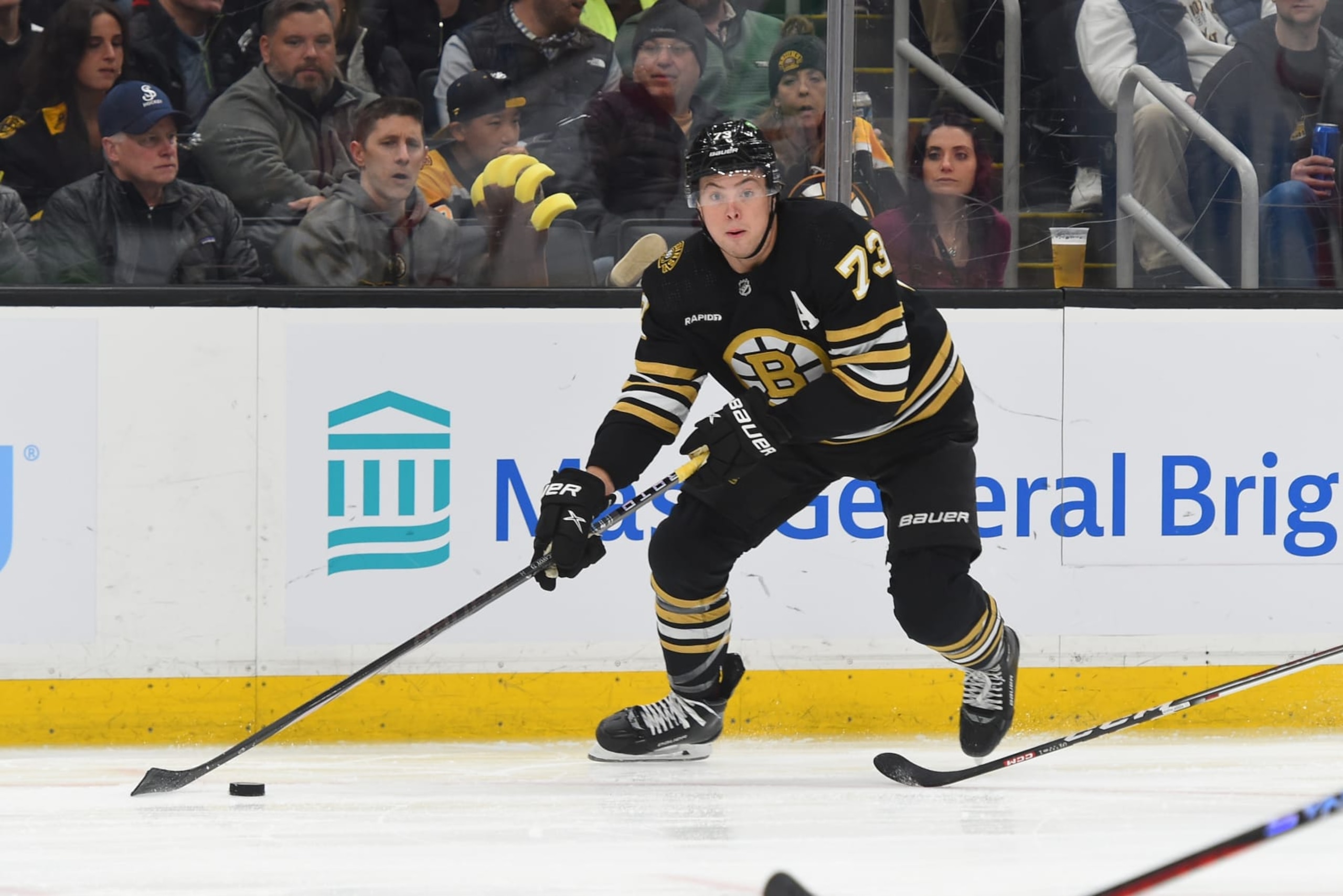 BOSTON, MASSACHUSETTS - JANUARY 24: Charlie McAvoy #73 of the Boston Bruins skates with the puck against the Carolina Hurricanes at the TD Garden on January 24, 2024 in Boston, Massachusetts. (Photo by Steve Babineau/NHLI via Getty Images)