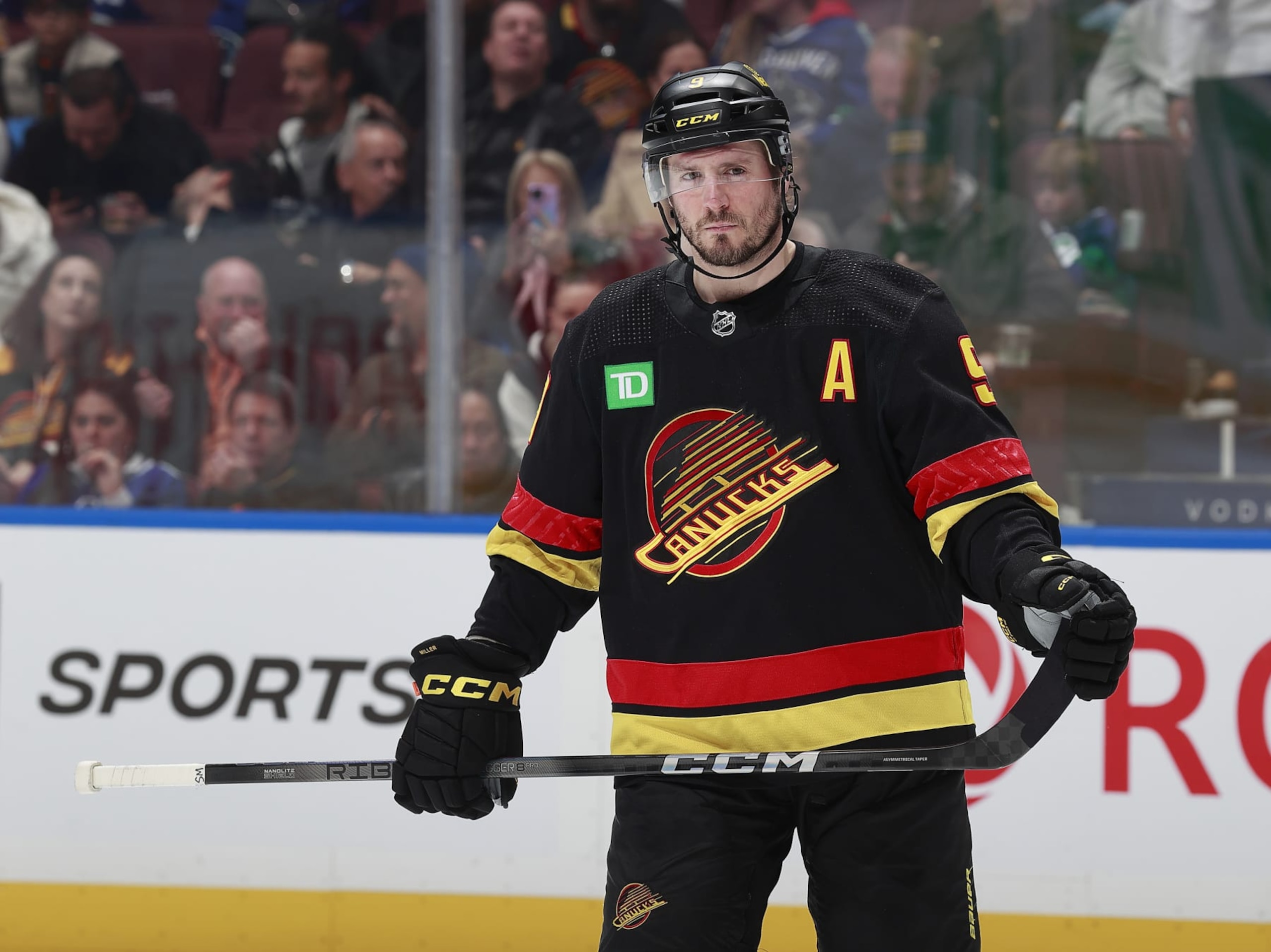 VANCOUVER, CANADA - JANUARY 27: J.T. Miller #9 of the Vancouver Canucks line up for a face off during their NHL game against the Columbus Blue Jackets at Rogers Arena on January 27, 2024 in Vancouver, British Columbia, Canada.  (Photo by Jeff Vinnick/NHLI via Getty Images)