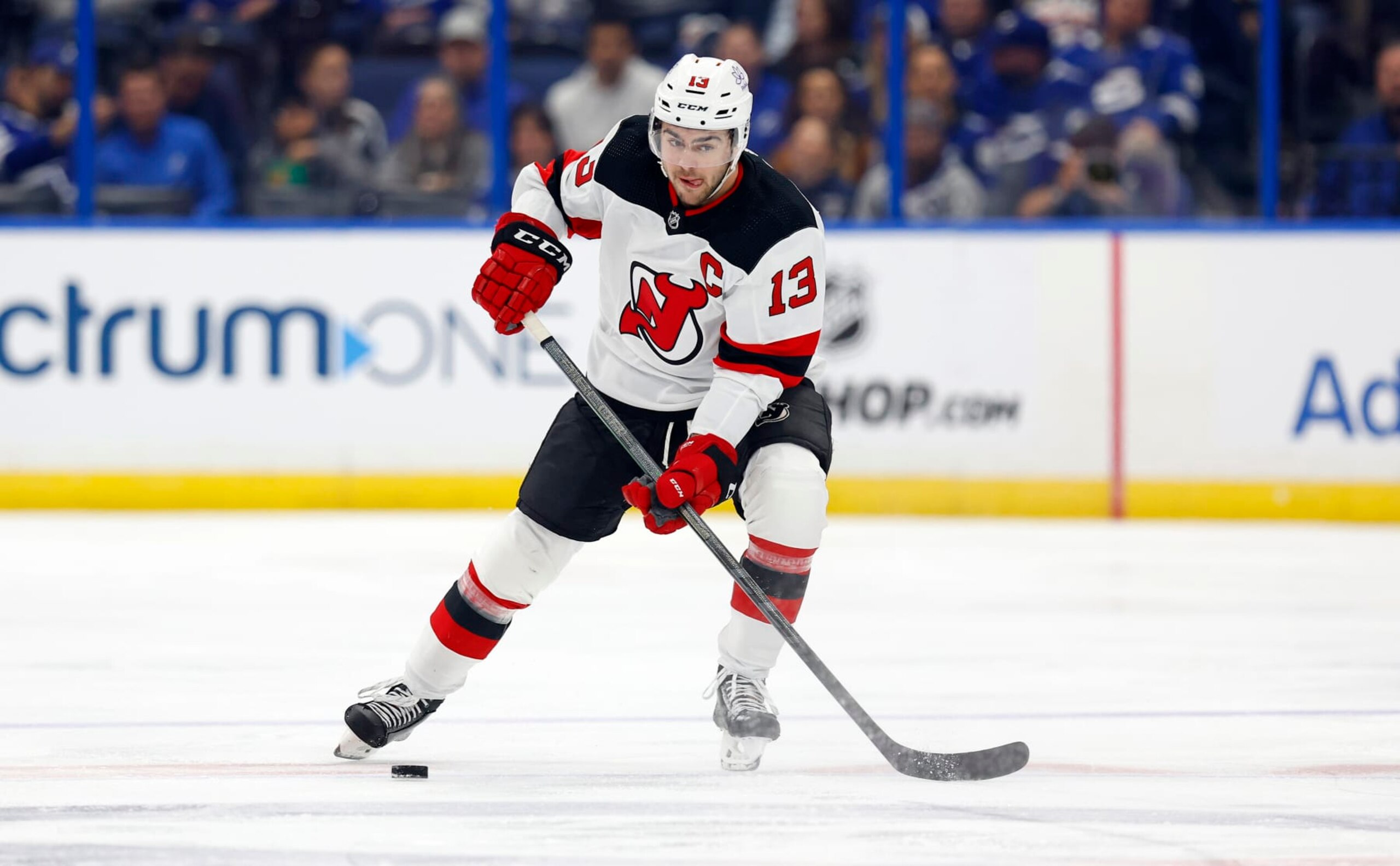 TAMPA, FLORIDA - JANUARY 11: Nico Hischier #13 of the New Jersey Devils looks to pass during a game against the Tampa Bay Lightning at Amalie Arena on January 11, 2024 in Tampa, Florida. (Photo by Mike Ehrmann/Getty Images)