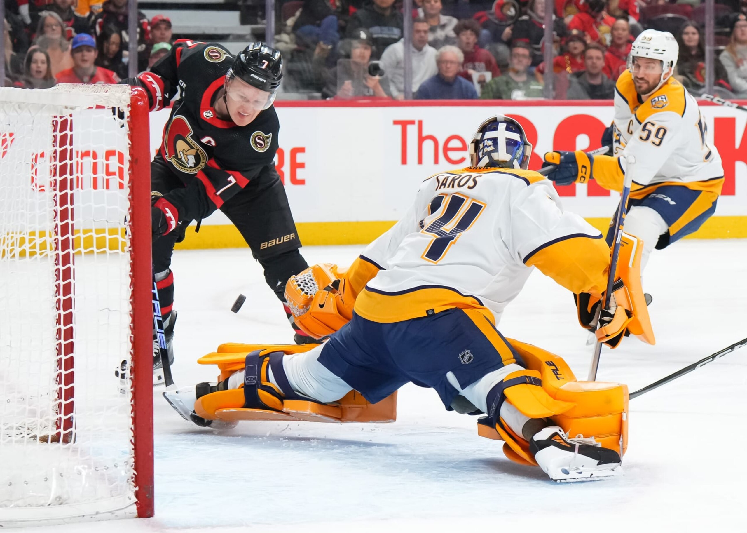 OTTAWA, CANADA - JANUARY 29: Juuse Saros #74 of the Nashville Predators makes a save against Brady Tkachuk #7 of the Ottawa Senators during the first period at Canadian Tire Centre on January 29, 2024 in Ottawa, Ontario, Canada.  (Photo by André Ringuette/NHLI via Getty Images)