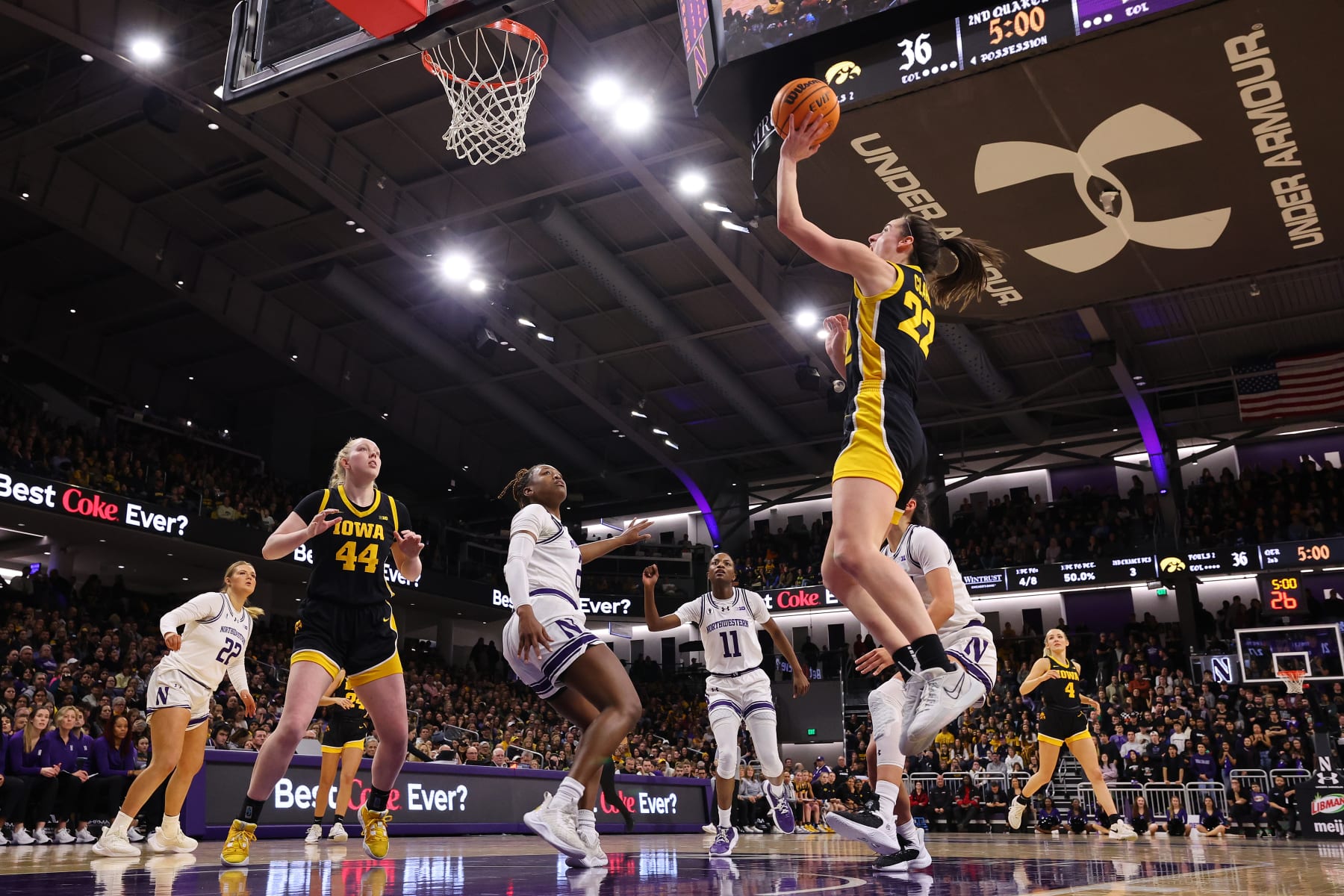 EVANSTON, ILLINOIS - JANUARY 31: Caitlin Clark #22 of the Iowa Hawkeyes scores her 3,403 career point, passing Kelsey Mitchell for second in Division I NCAA women's basketball history, during the second quarter against the Northwestern Wildcats at Welsh-Ryan Arena on January 31, 2024 in Evanston, Illinois. (Photo by Michael Reaves/Getty Images)
