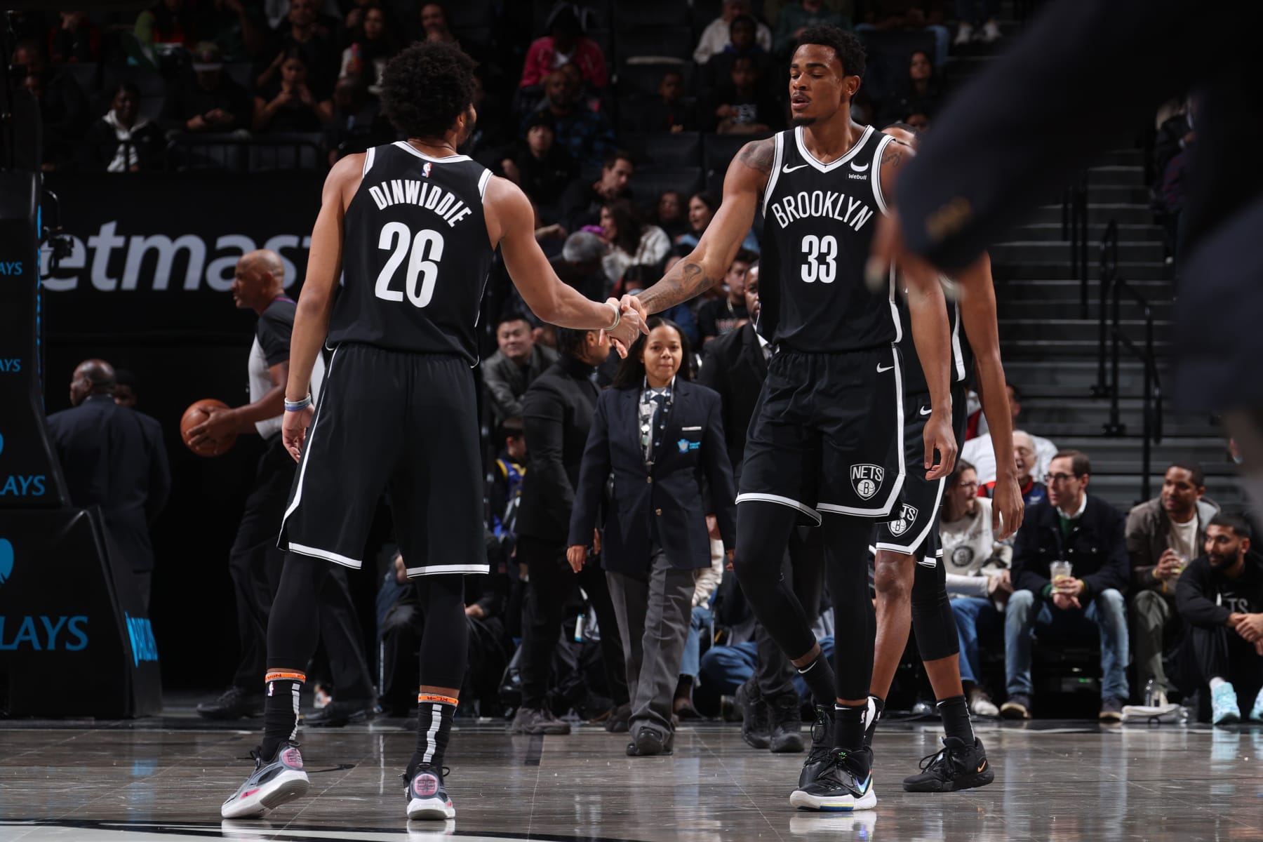 BROOKLYN, NY - NOVEMBER 25: Nicolas Claxton #33 and Spencer Dinwiddie #26 of the Brooklyn Nets high five during the game against the Miami Heat on November 25, 2023 at Barclays Center in Brooklyn, New York. NOTE TO USER: User expressly acknowledges and agrees that, by downloading and or using this Photograph, user is consenting to the terms and conditions of the Getty Images License Agreement. Mandatory Copyright Notice: Copyright 2023 NBAE (Photo by Nathaniel S. Butler/NBAE via Getty Images)