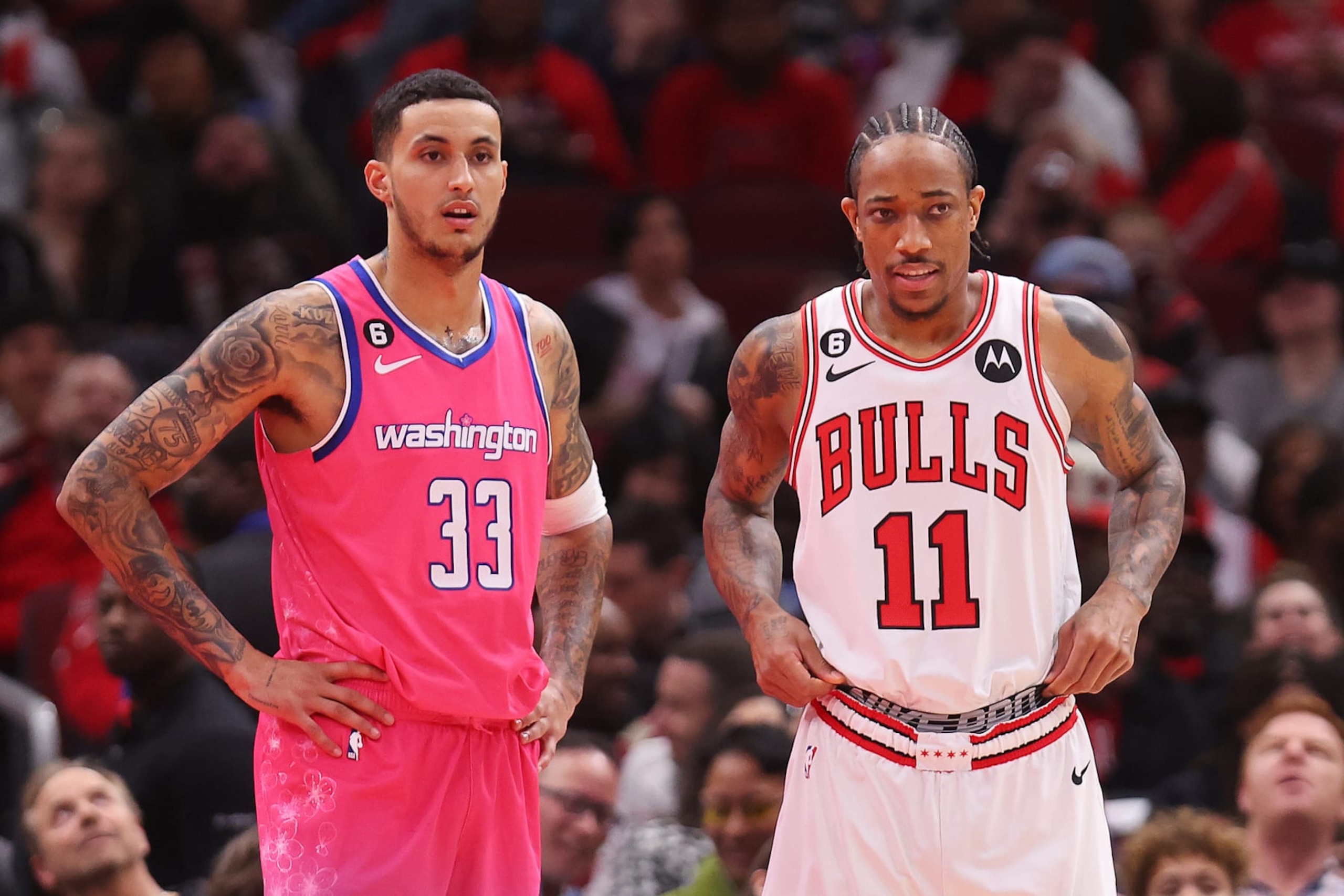 CHICAGO, ILLINOIS - FEBRUARY 26: Kyle Kuzma #33 of the Washington Wizards and DeMar DeRozan #11 of the Chicago Bulls looks on during the first half at United Center on February 26, 2023 in Chicago, Illinois. NOTE TO USER: User expressly acknowledges and agrees that, by downloading and or using this photograph, User is consenting to the terms and conditions of the Getty Images License Agreement.  (Photo by Michael Reaves/Getty Images)