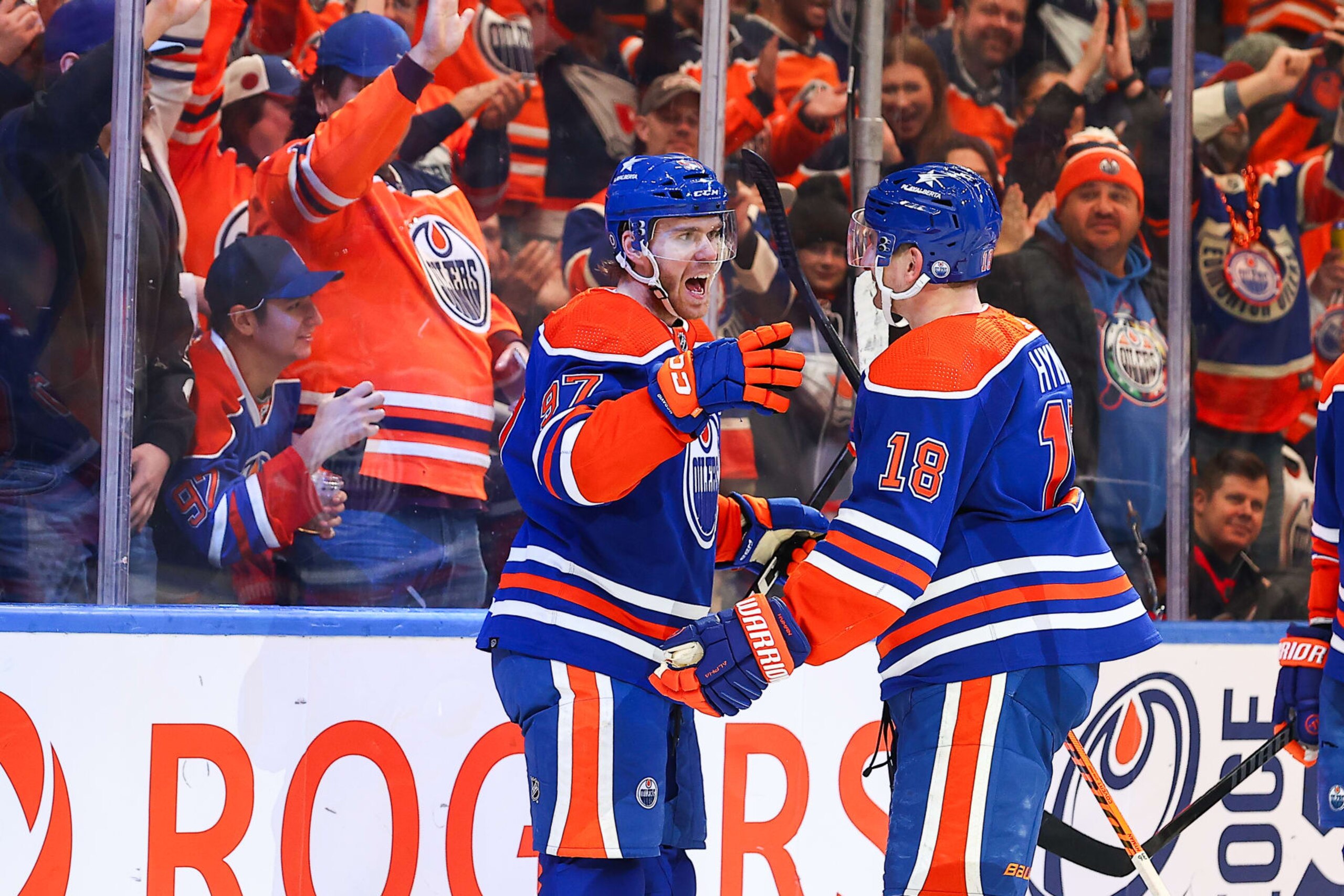 EDMONTON, AB - JANUARY 6: Edmonton Oilers Center Connor McDavid (97) and Edmonton Oilers Right Wing Zach Hyman (18) celebrate a Hyman hatrick in the third period of the Edmonton Oilers game versus the Ottawa Senators on January 6, 2024 at Rogers Place in Edmonton, AB. (Photo by Curtis Comeau/Icon Sportswire via Getty Images)