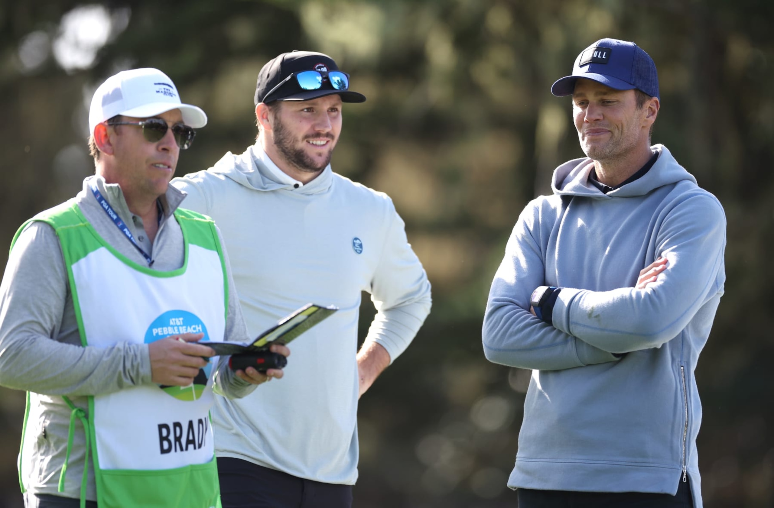 PEBBLE BEACH, CALIFORNIA - FEBRUARY 01: Former NFL quarterback Tom Brady, right, and Josh Allen of the NFL Buffalo Bills, center, look on during the first round of the AT&T Pebble Beach Pro-Am at Spyglass Hill Golf Course on February 01, 2024 in Pebble Beach, California. (Photo by Ezra Shaw/Getty Images) PEBBLE BEACH, CALIFORNIA - FEBRUARY 01: Former NFL quarterback Tom Brady, right, and Josh Allen of the NFL Buffalo Bills, center, look on during the first round of the AT&T Pebble Beach Pro-Am at Spyglass Hill Golf Course on February 01, 2024 in Pebble Beach, California. (Photo by Ezra Shaw/Getty Images)