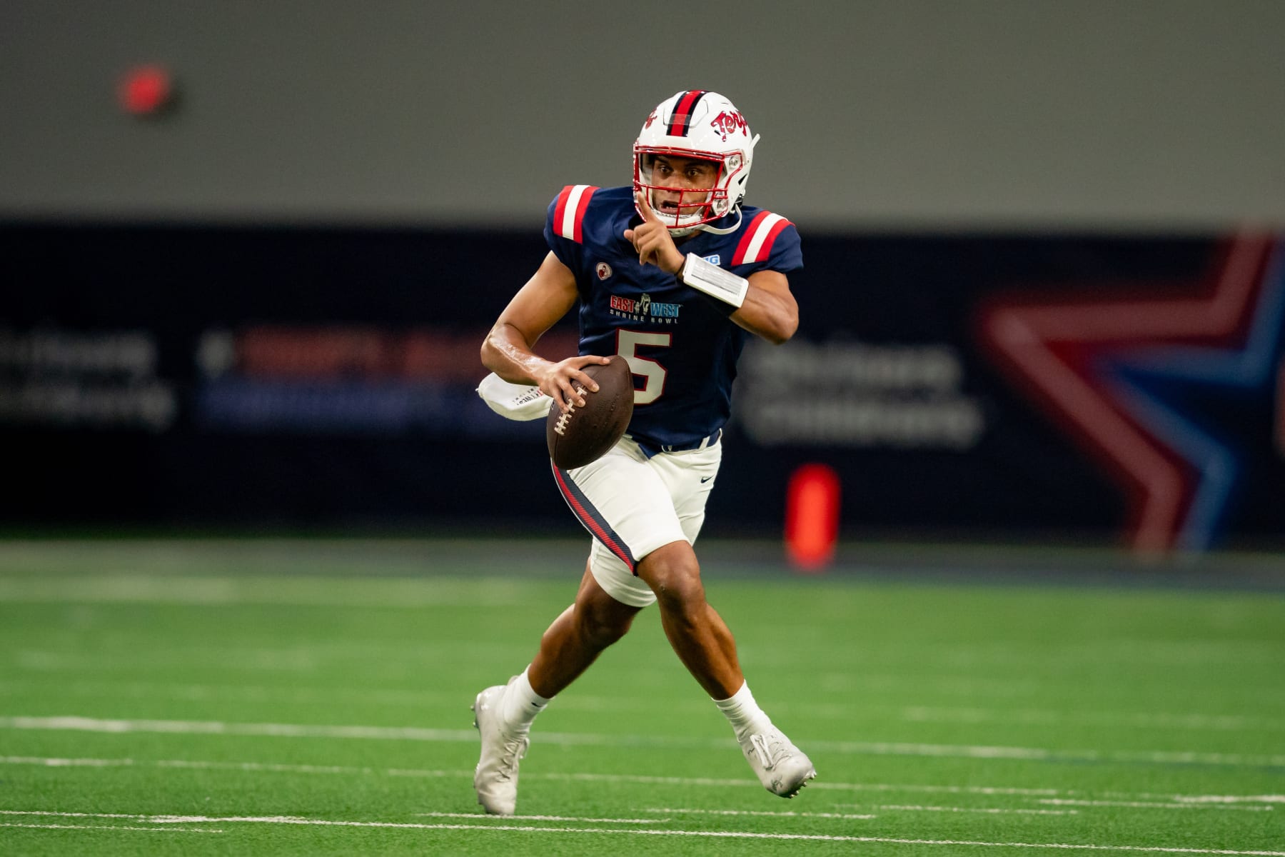 FRISCO, TX - FEBRUARY 01: West Team quarterback Taulia Tagovailoa (5) points to a receiver as he rolls out during the East-West Shrine Bowl game on February 1, 2024 at the Ford Center at the star in Frisco, TX. (Photo by Chris Leduc/Icon Sportswire via Getty Images)