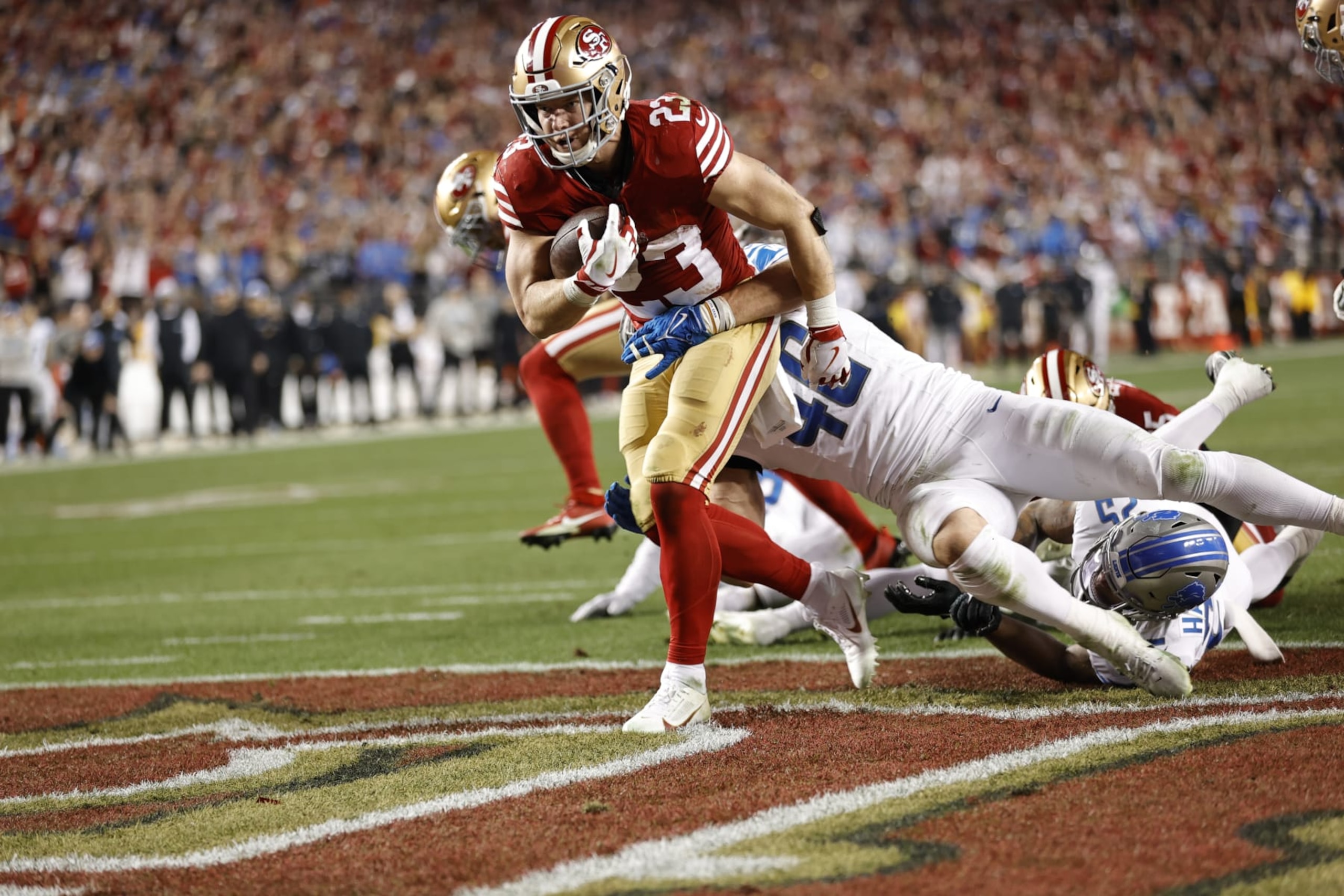 SANTA CLARA, CA - JANUARY 28: Christian McCaffrey #23 of the San Francisco 49ers rushes for a 1-yard touchdown during the NFC Championship game against the Detroit Lions at Levi's Stadium on January 28, 2024 in Santa Clara, California. The 49ers defeated the Lions 34-31. (Photo by Michael Zagaris/San Francisco 49ers/Getty Images)
