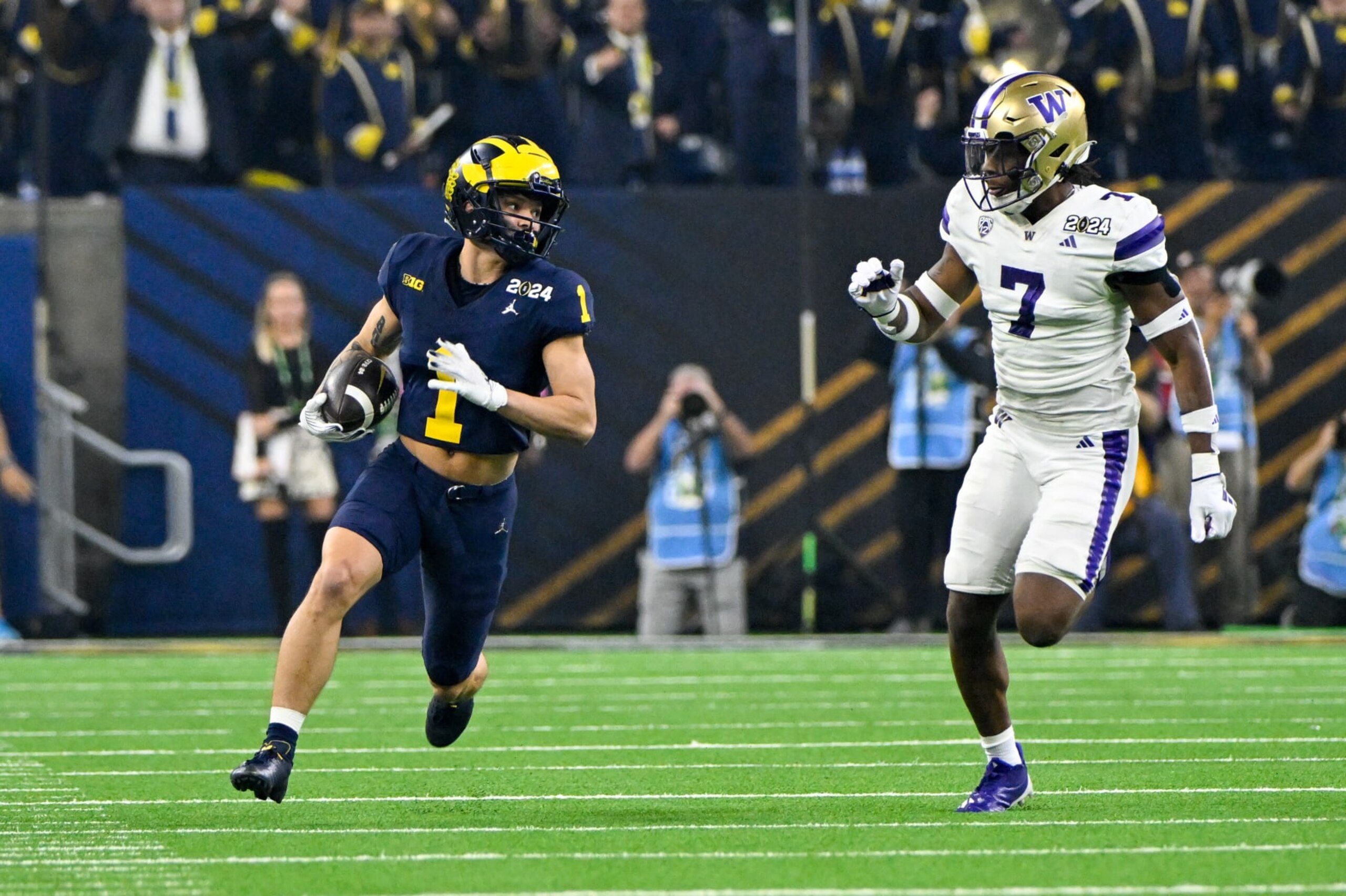 HOUSTON, TX - JANUARY 08: Michigan Wolverines wide receiver Roman Wilson (1) gets to the edge after a pass reception as Washington Huskies cornerback Dominique Hampton (7) defends during the CFP National Championship football game between the Washington Huskies and Michigan Wolverines at NRG Stadium on January 8, 2024 in Houston, Texas. (Photo by Ken Murray/Icon Sportswire via Getty Images)