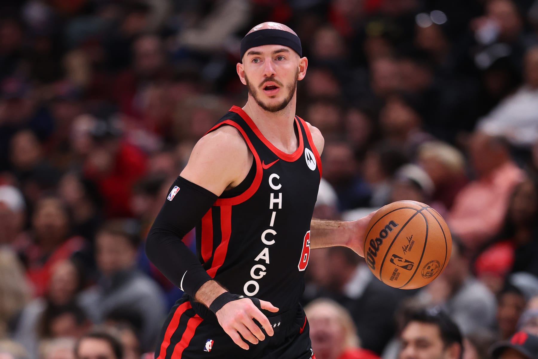 CHICAGO, ILLINOIS - JANUARY 30: Alex Caruso #6 of the Chicago Bulls dribbles up the court against the Toronto Raptors during the first half at the United Center on January 30, 2024 in Chicago, Illinois. NOTE TO USER: User expressly acknowledges and agrees that, by downloading and or using this photograph, User is consenting to the terms and conditions of the Getty Images License Agreement.  (Photo by Michael Reaves/Getty Images)