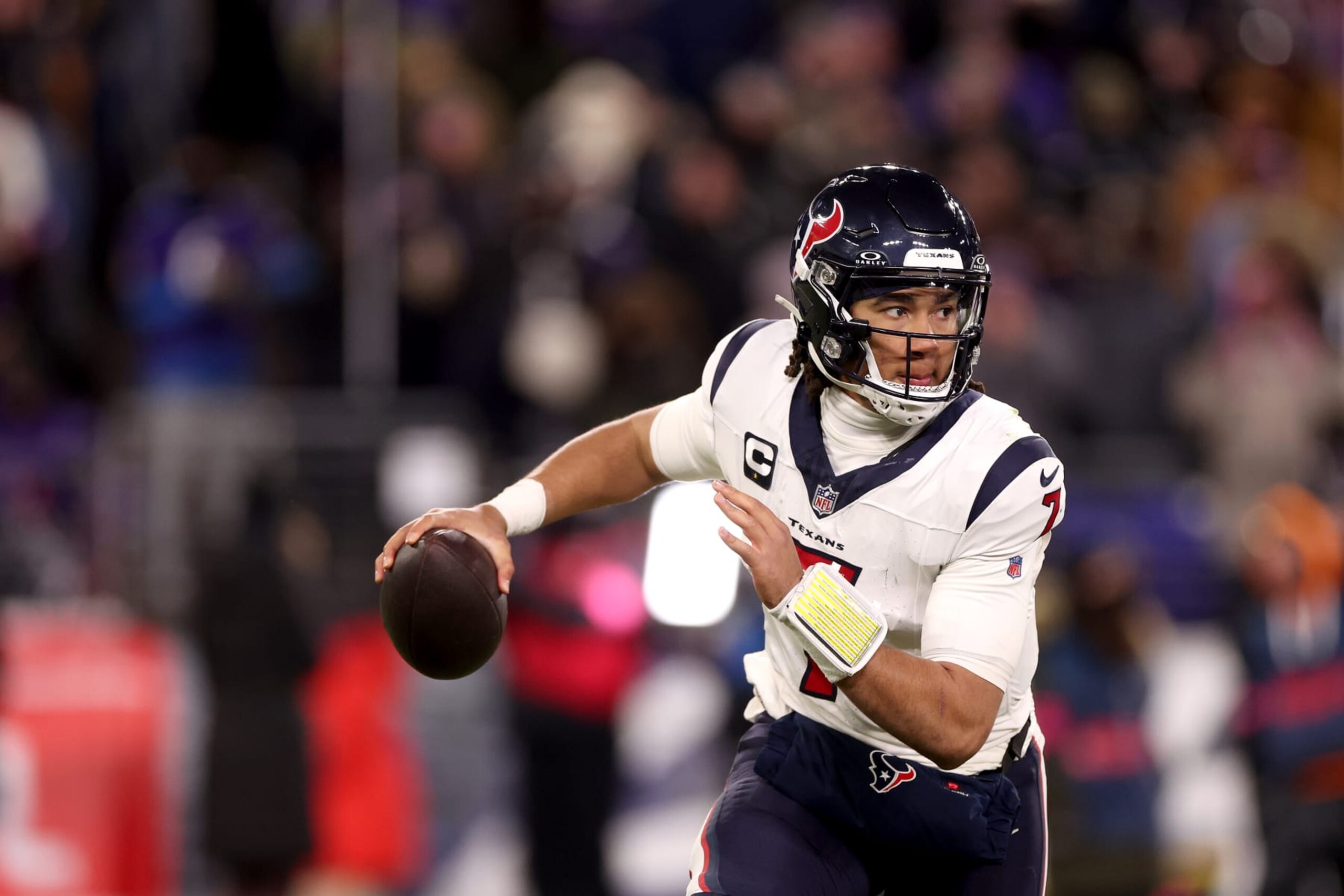 BALTIMORE, MARYLAND - JANUARY 20: Quarterback C.J. Stroud #7 of the Houston Texans rolls out to pass against the Baltimore Ravens in the second half at M&T Bank Stadium on January 20, 2024 in Baltimore, Maryland. (Photo by Rob Carr/Getty Images)