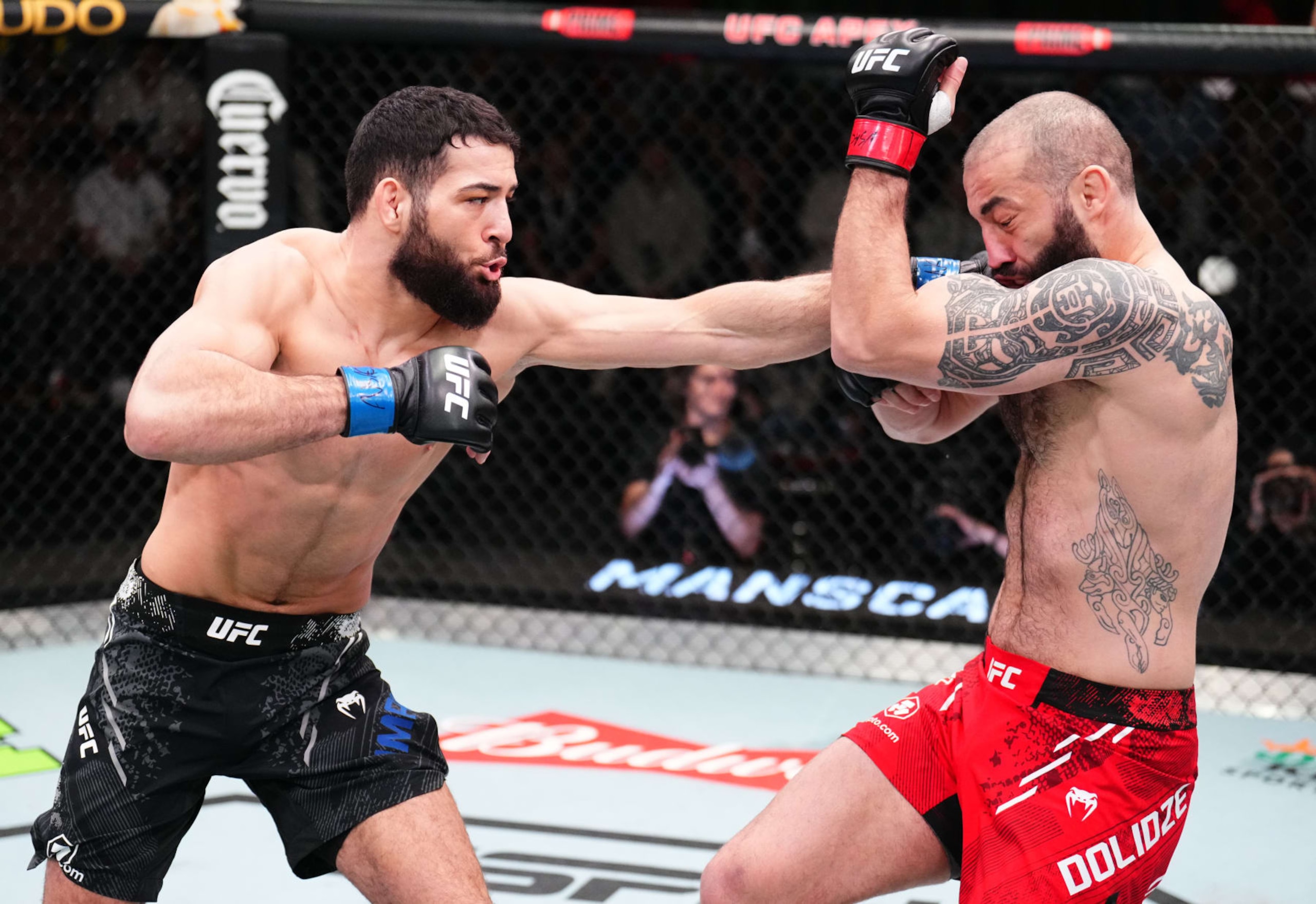 LAS VEGAS, NEVADA - FEBRUARY 03: (L-R) Nassourdine Imavov of Russia punches Roman Dolidze of Georgia in a middleweight fight during the UFC Fight Night event at UFC APEX on February 03, 2024 in Las Vegas, Nevada. (Photo by Chris Unger/Zuffa LLC via Getty Images) LAS VEGAS, NEVADA - FEBRUARY 03: (L-R) Nassourdine Imavov of Russia punches Roman Dolidze of Georgia in a middleweight fight during the UFC Fight Night event at UFC APEX on February 03, 2024 in Las Vegas, Nevada. (Photo by Chris Unger/Zuffa LLC via Getty Images)