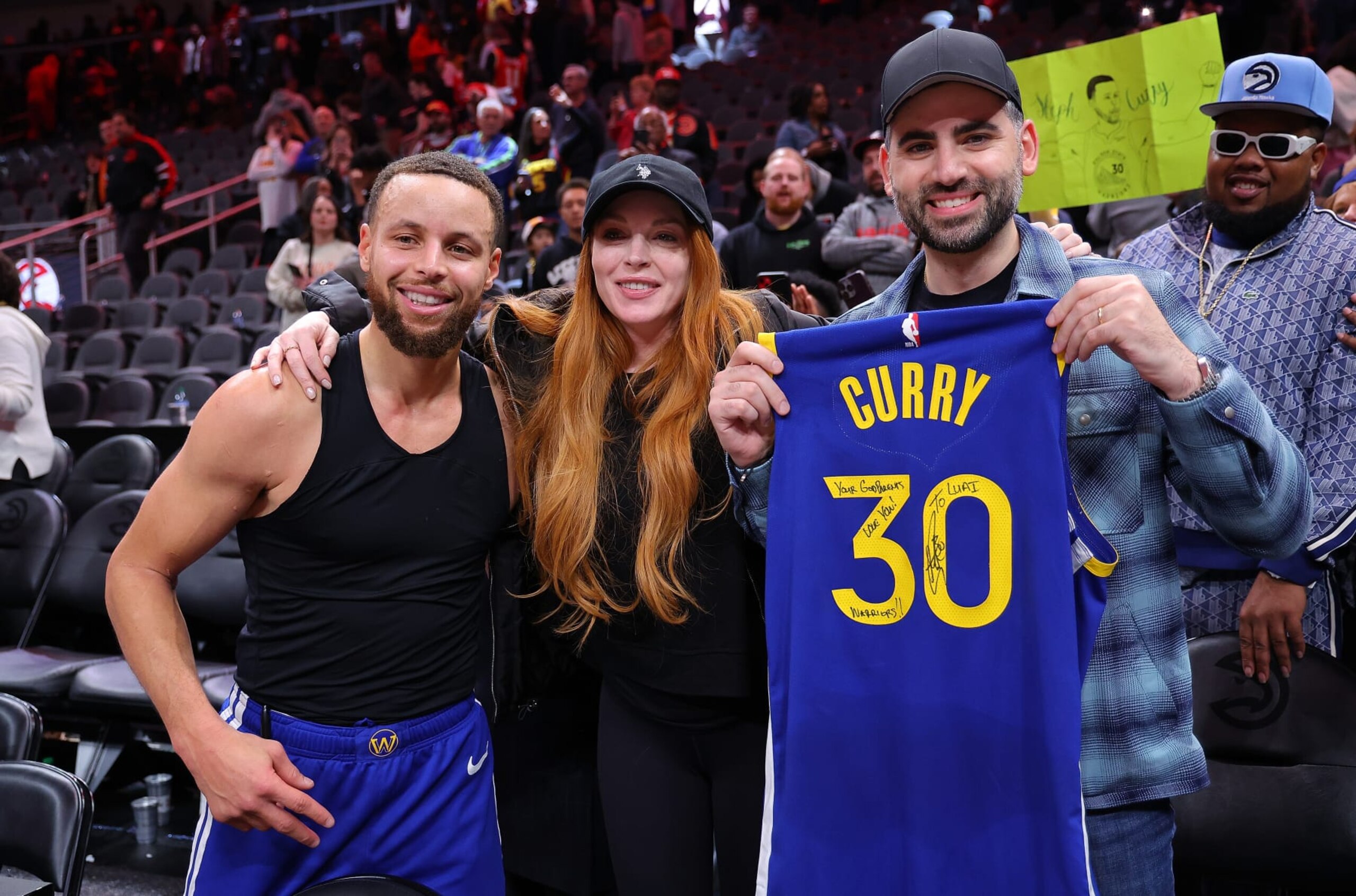 ATLANTA, GEORGIA - FEBRUARY 03: Stephen Curry #30 of the Golden State Warriors poses with actress Lindsay Lohan and her husband Bader Shammas after giving them his jersey in their 141-134 overtime loss to the Atlanta Hawks at State Farm Arena on February 03, 2024 in Atlanta, Georgia. NOTE TO USER: User expressly acknowledges and agrees that, by downloading and/or using this photograph, user is consenting to the terms and conditions of the Getty Images License Agreement. (Photo by Kevin C. Cox/Getty Images) ATLANTA, GEORGIA - FEBRUARY 03: Stephen Curry #30 of the Golden State Warriors poses with actress Lindsay Lohan and her husband Bader Shammas after giving them his jersey in their 141-134 overtime loss to the Atlanta Hawks at State Farm Arena on February 03, 2024 in Atlanta, Georgia. NOTE TO USER: User expressly acknowledges and agrees that, by downloading and/or using this photograph, user is consenting to the terms and conditions of the Getty Images License Agreement. (Photo by Kevin C. Cox/Getty Images)