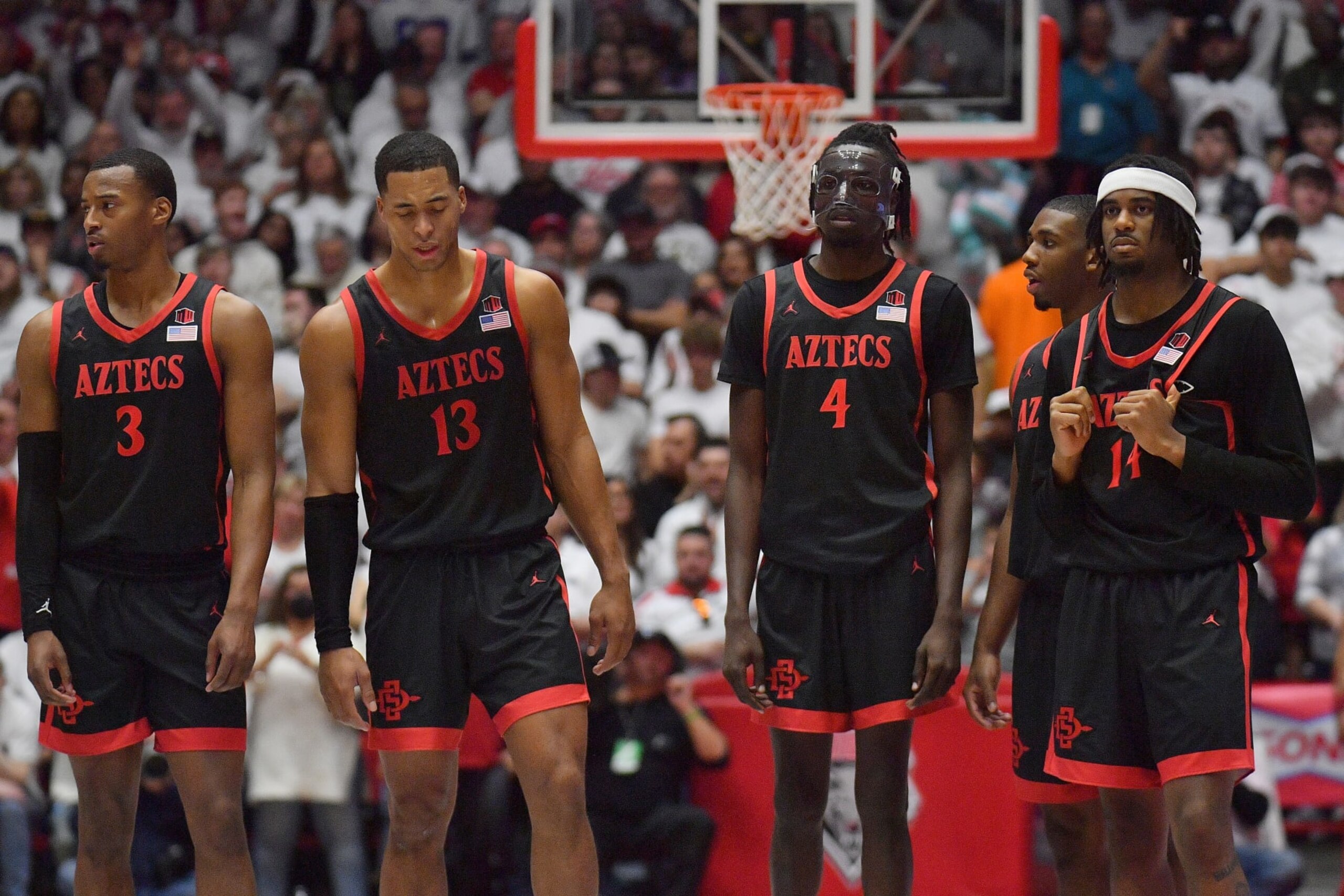 ALBUQUERQUE, NEW MEXICO - JANUARY 13: (L-R) Micah Parrish #3, Jaedon LeDee #13, Jay Pal #4, Lamont Butler #5 and Reese Waters #14 of the San Diego State Aztecs stand on the court during a timeout in the second half of their game against the New Mexico Lobos at The Pit on January 13, 2024 in Albuquerque, New Mexico. The Lobos defeated the Aztecs 88-70. (Photo by Sam Wasson/Getty Images)