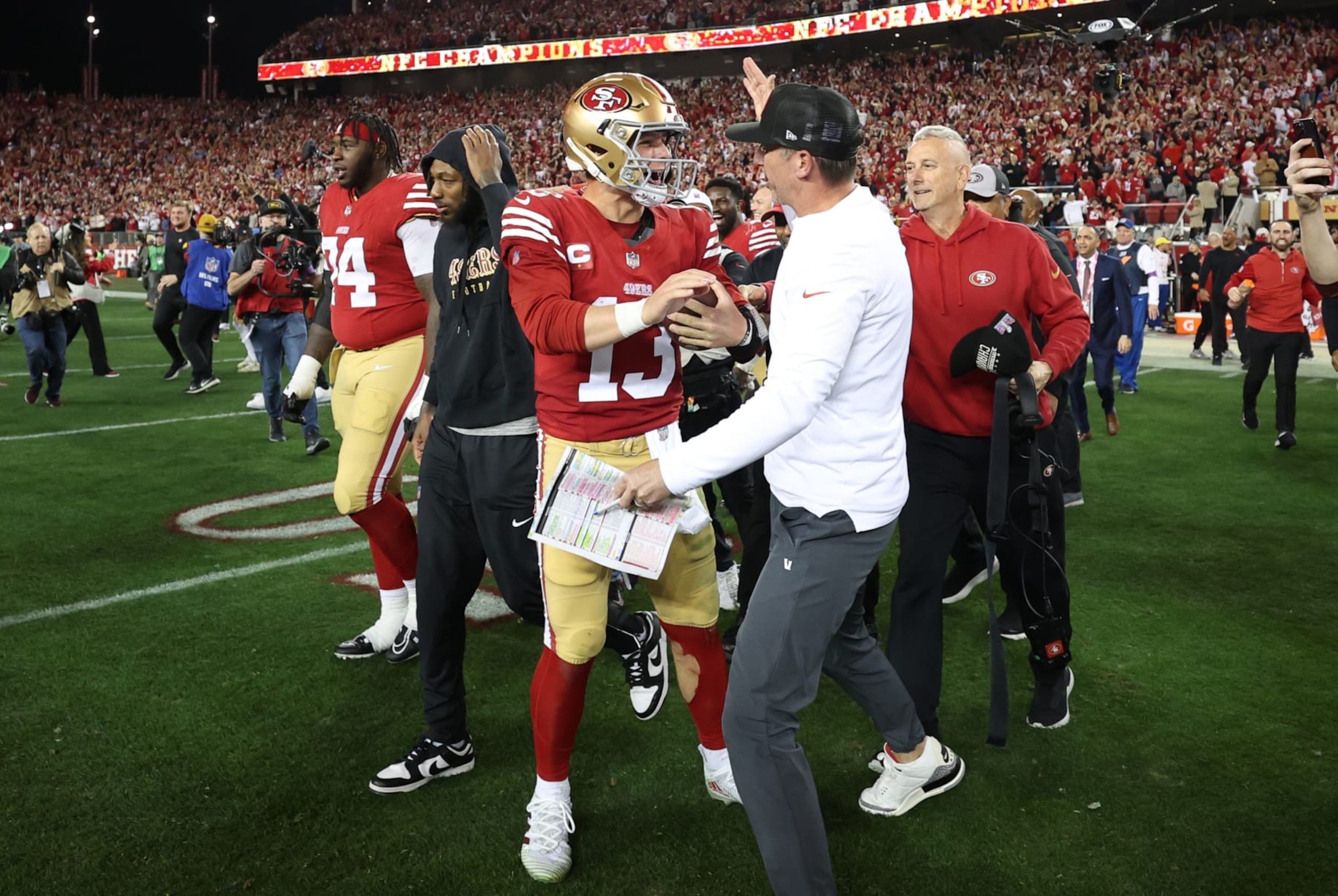 SANTA CLARA, CALIFORNIA - JANUARY 28: Brock Purdy #13 of the San Francisco 49ers celebrates with Head coach Kyle Shanahan  after defeating the Detroit Lions 34-31 in the NFC Championship Game at Levi's Stadium on January 28, 2024 in Santa Clara, California. (Photo by Ezra Shaw/Getty Images)