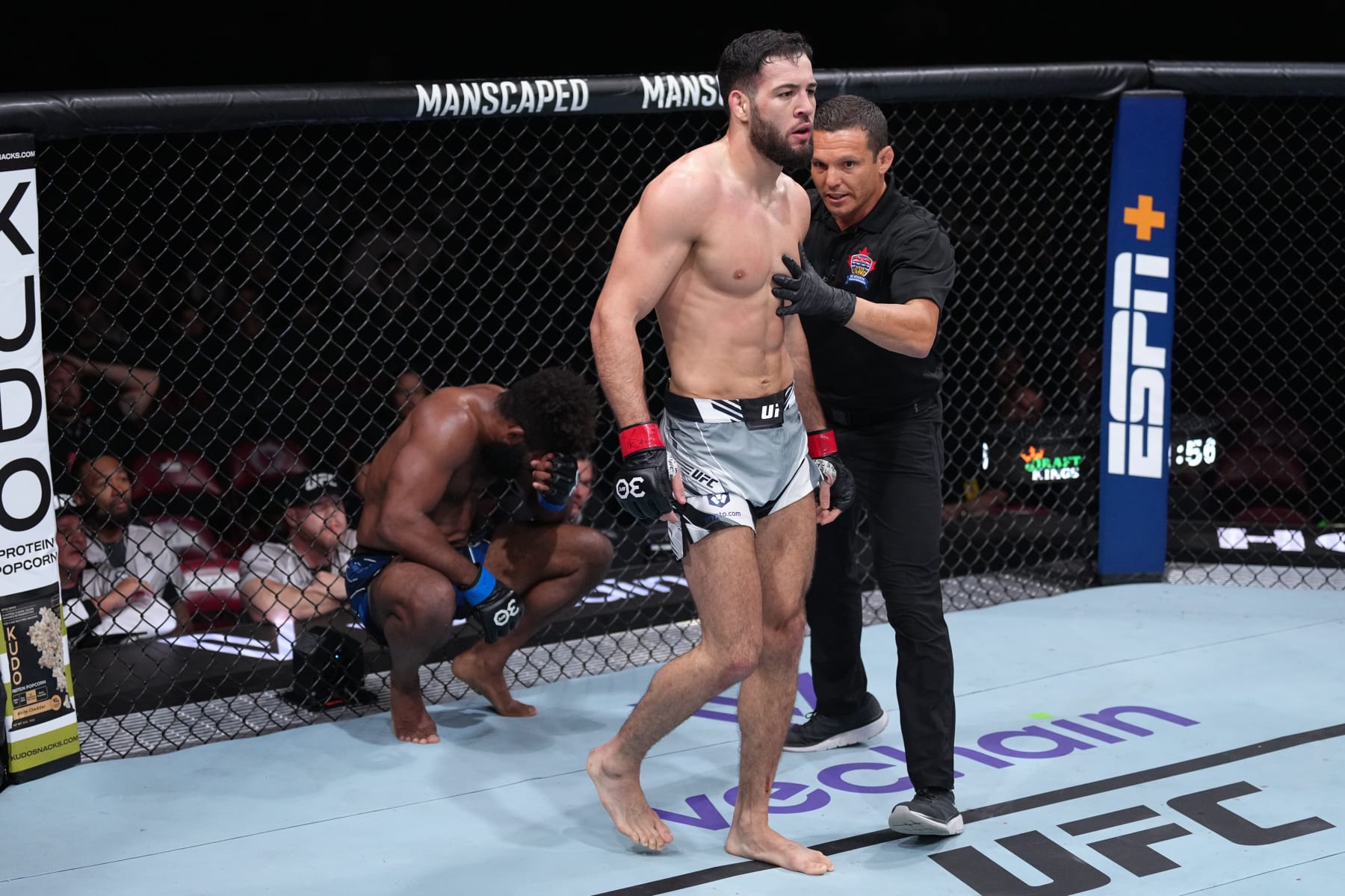 Chris Curtis (left) reacts to a head butt from Nassourdine Imavov