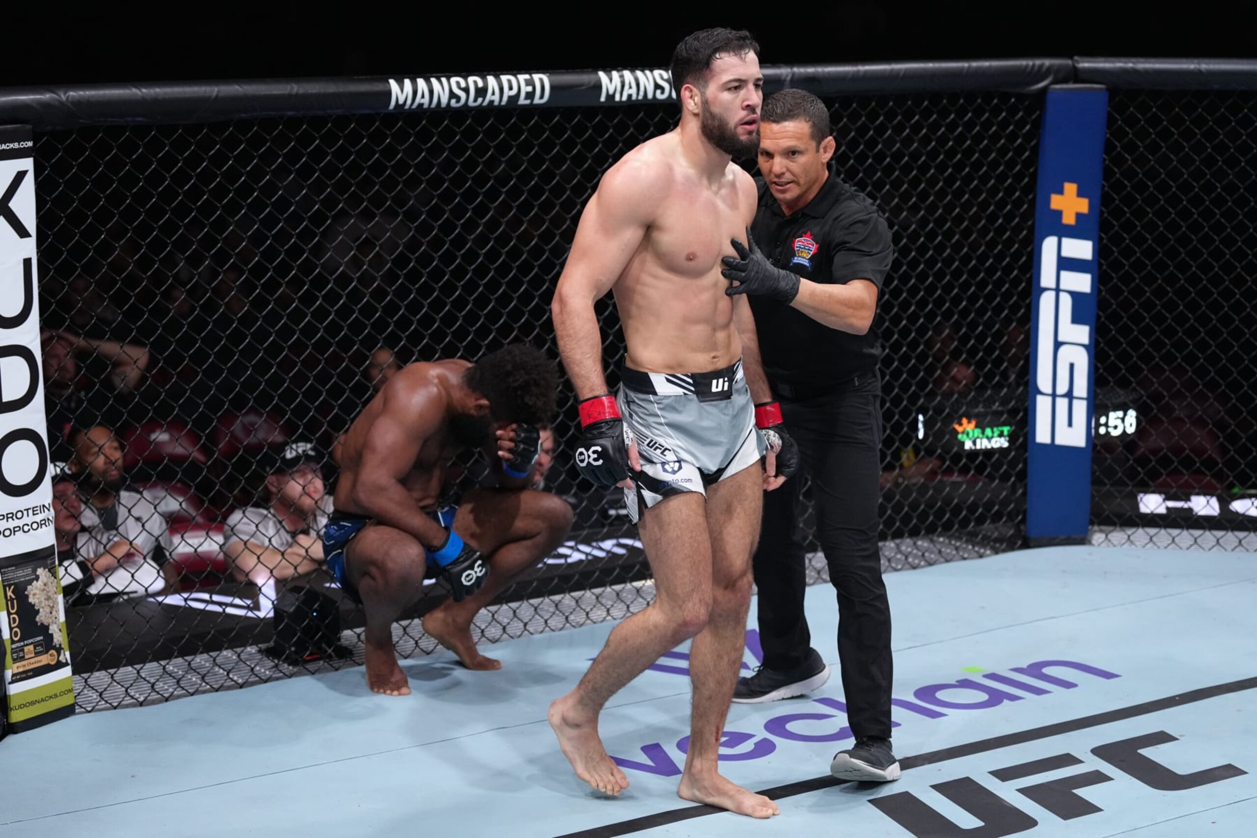 Chris Curtis (left) reacts to a head butt from Nassourdine Imavov