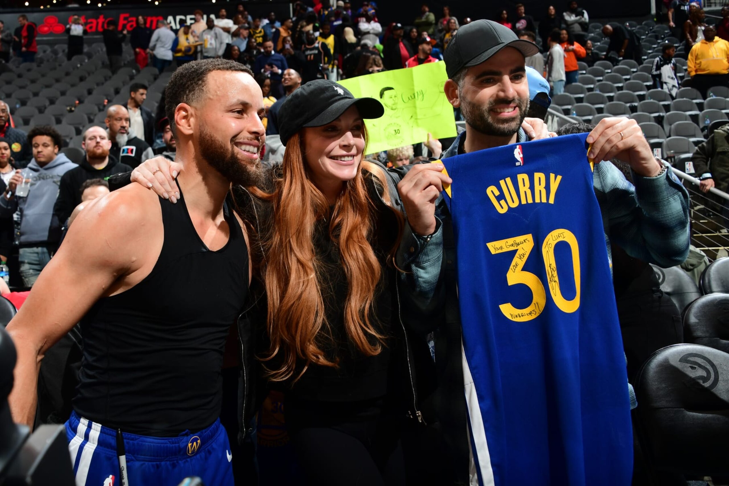 ATLANTA, GA - FEBRUARY 3: Stephen Curry #30 of the Golden State Warriors poses for a portrait with Lindsay Lohan and Bader Shammas after the game against the Atlanta Hawks on February 3, 2024 at State Farm Arena in Atlanta, Georgia.  NOTE TO USER: User expressly acknowledges and agrees that, by downloading and/or using this Photograph, user is consenting to the terms and conditions of the Getty Images License Agreement. Mandatory Copyright Notice: Copyright 2024 NBAE (Photo by Scott Cunningham/NBAE via Getty Images)