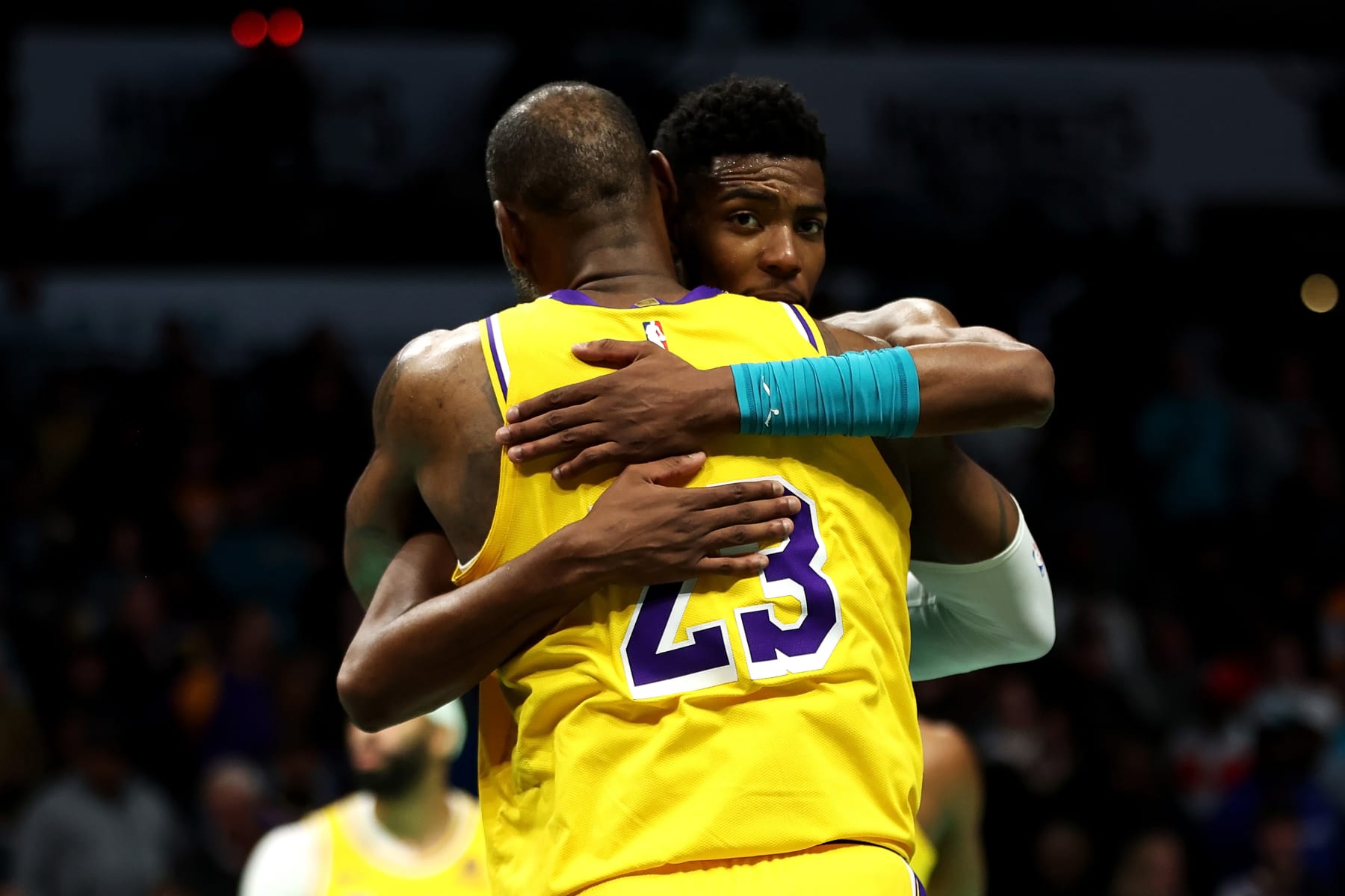 CHARLOTTE, NORTH CAROLINA - FEBRUARY 05: LeBron James #23 of the Los Angeles Lakers embraces Brandon Miller #24 of the Charlotte Hornets after a game at Spectrum Center on February 05, 2024 in Charlotte, North Carolina. NOTE TO USER: User expressly acknowledges and agrees that, by downloading and or using this photograph, User is consenting to the terms and conditions of the Getty Images License Agreement. (Photo by David Jensen/Getty Images)