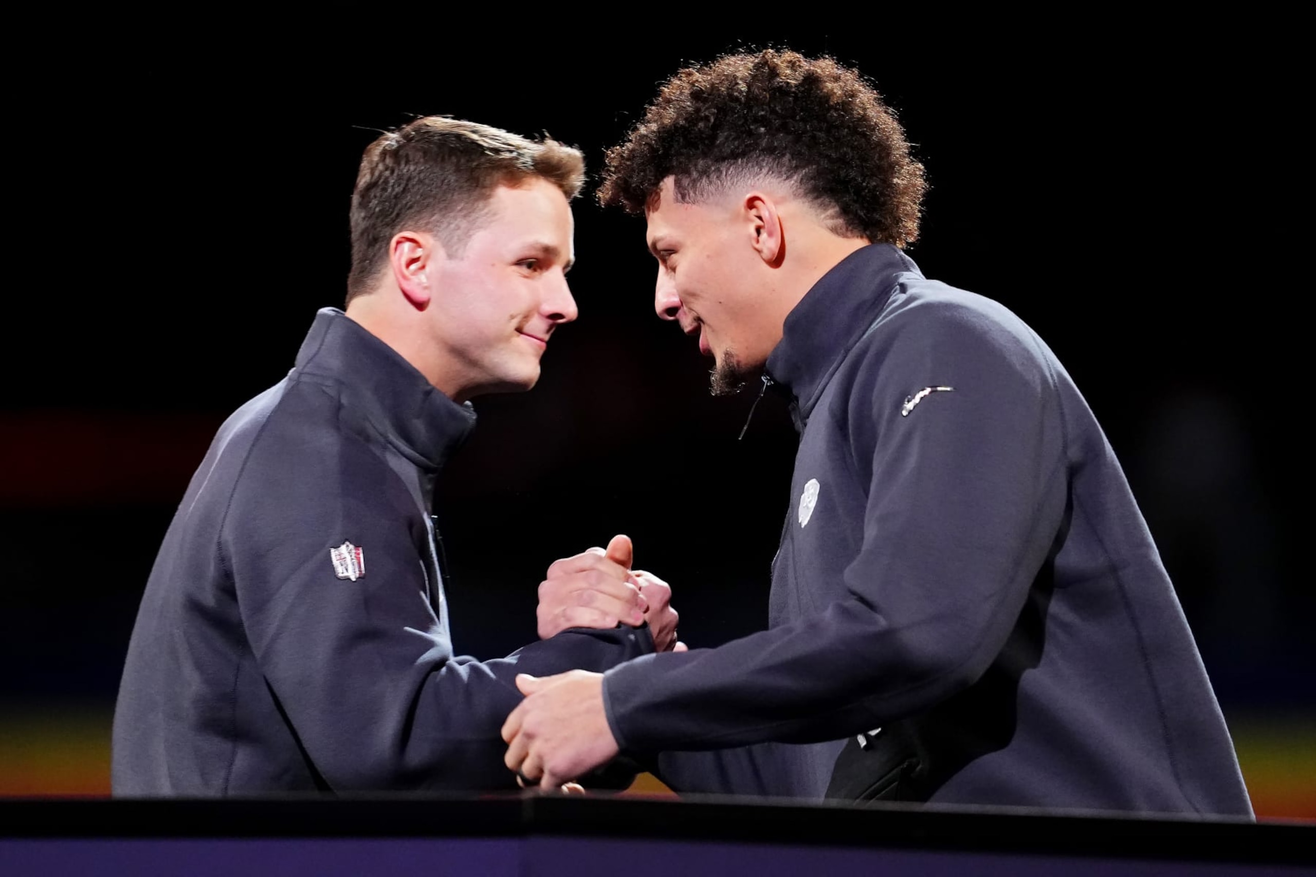 LAS VEGAS, NEVADA - FEBRUARY 05: Brock Purdy of the San Francisco 49ers (L) and Patrick Mahomes of the Kansas City Chiefs meet on stage during Super Bowl LVIII Opening Night at Allegiant Stadium on February 05, 2024 in Las Vegas, Nevada. (Photo by Chris Unger/Getty Images)
