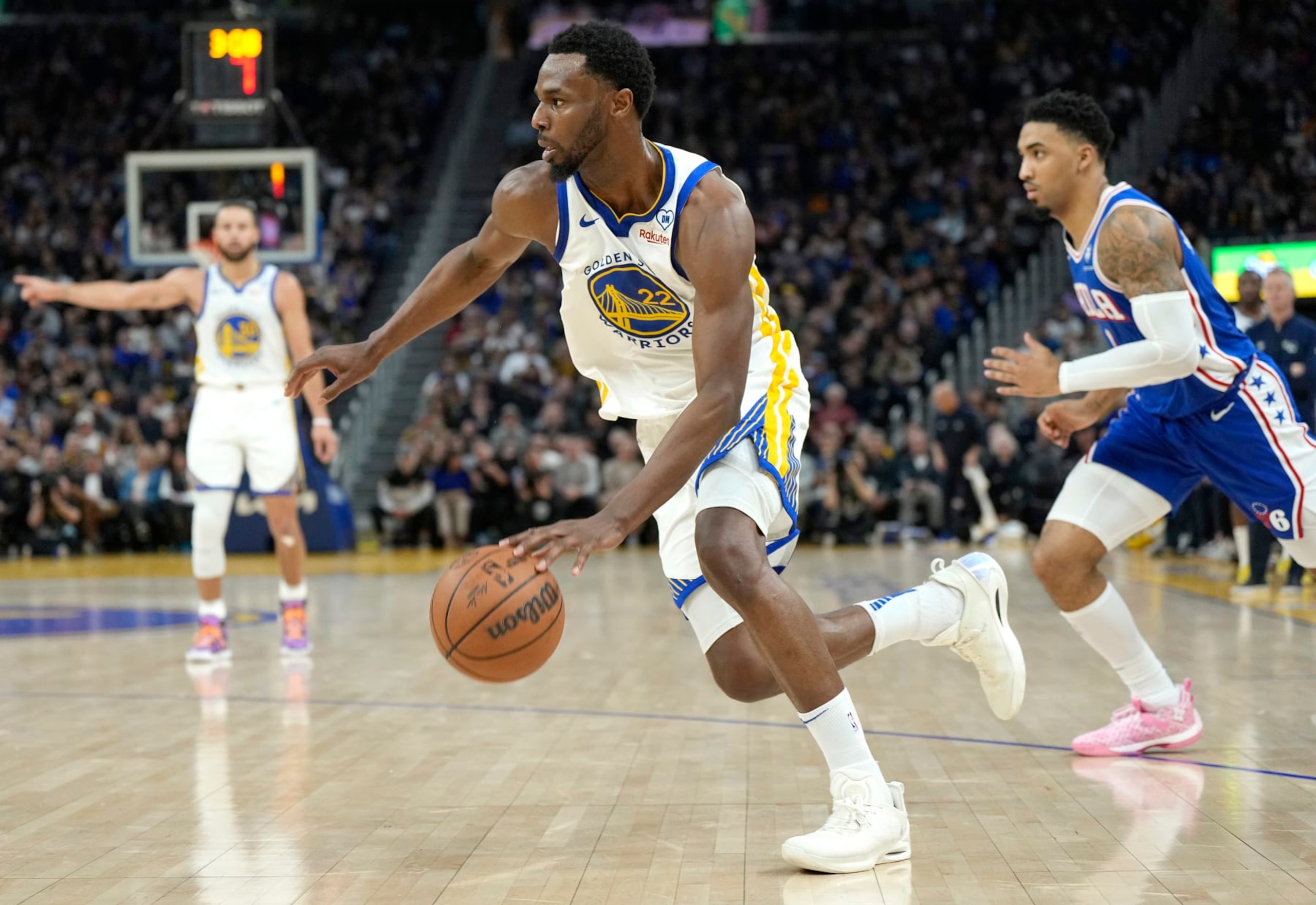 SAN FRANCISCO, CALIFORNIA - JANUARY 30: Andrew Wiggins #22 of the Golden State Warriors drives to the basket past KJ Martin #1 of the Philadelphia 76ers during the third quarter of an NBA basketball game at Chase Center on January 30, 2024 in San Francisco, California. NOTE TO USER: User expressly acknowledges and agrees that, by downloading and or using this photograph, User is consenting to the terms and conditions of the Getty Images License Agreement. (Photo by Thearon W. Henderson/Getty Images)