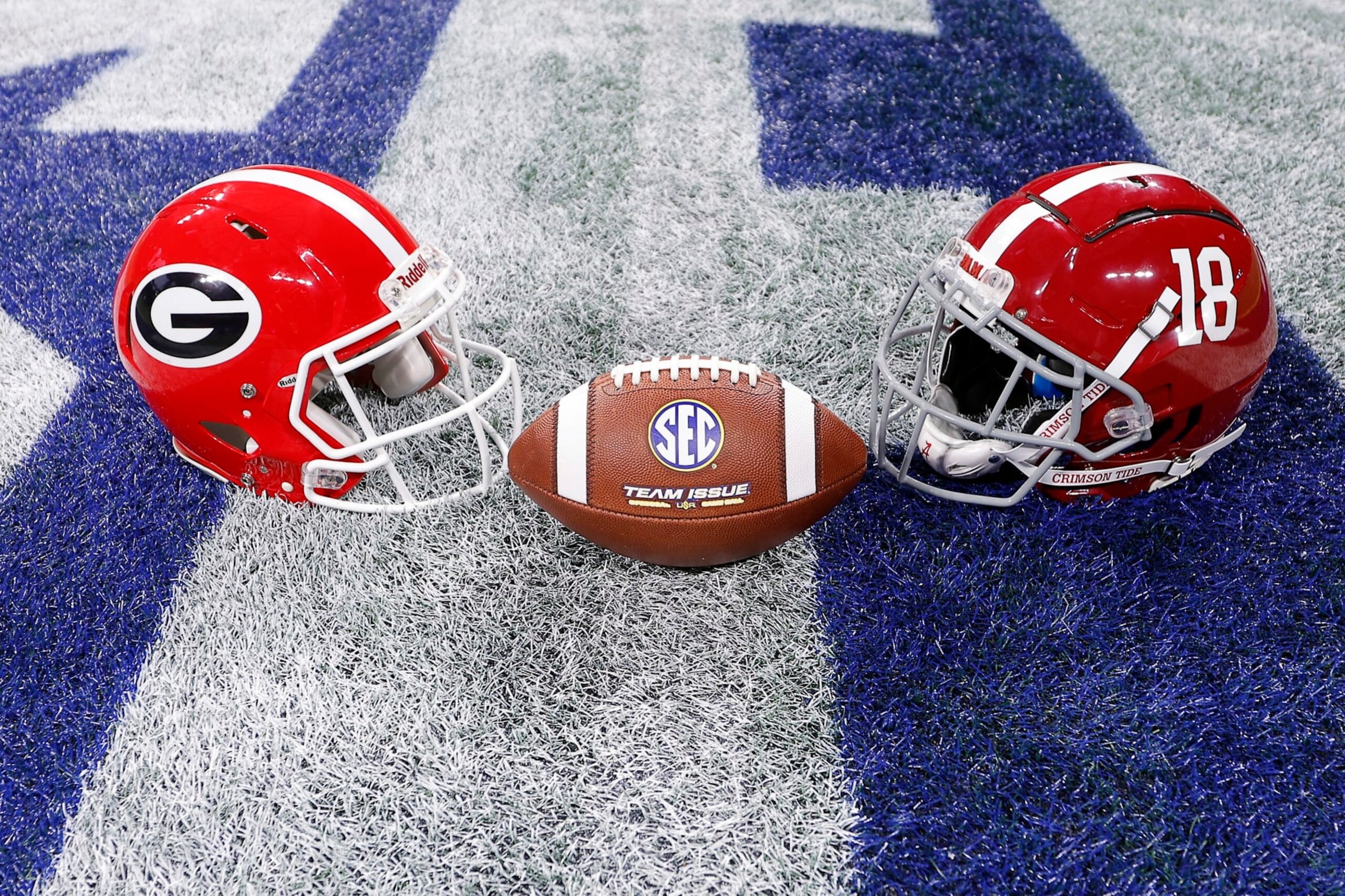 ATLANTA, GEORGIA - DECEMBER 02: A general view of the Alabama Crimson Tide and Georgia Bulldogs helmets at centerfield prior to the SEC Championship game at Mercedes-Benz Stadium on December 02, 2023 in Atlanta, Georgia. (Photo by Todd Kirkland/Getty Images)