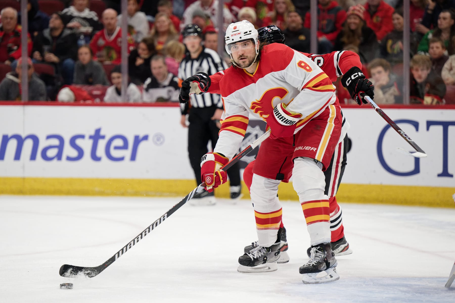 CHICAGO, ILLINOIS - JANUARY 07:  Chris Tanev #8 of the Calgary Flames skates against the Chicago Blackhawks on January 07, 2024 at United Center in Chicago, Illinois.  (Photo by Jamie Sabau/Getty Images)