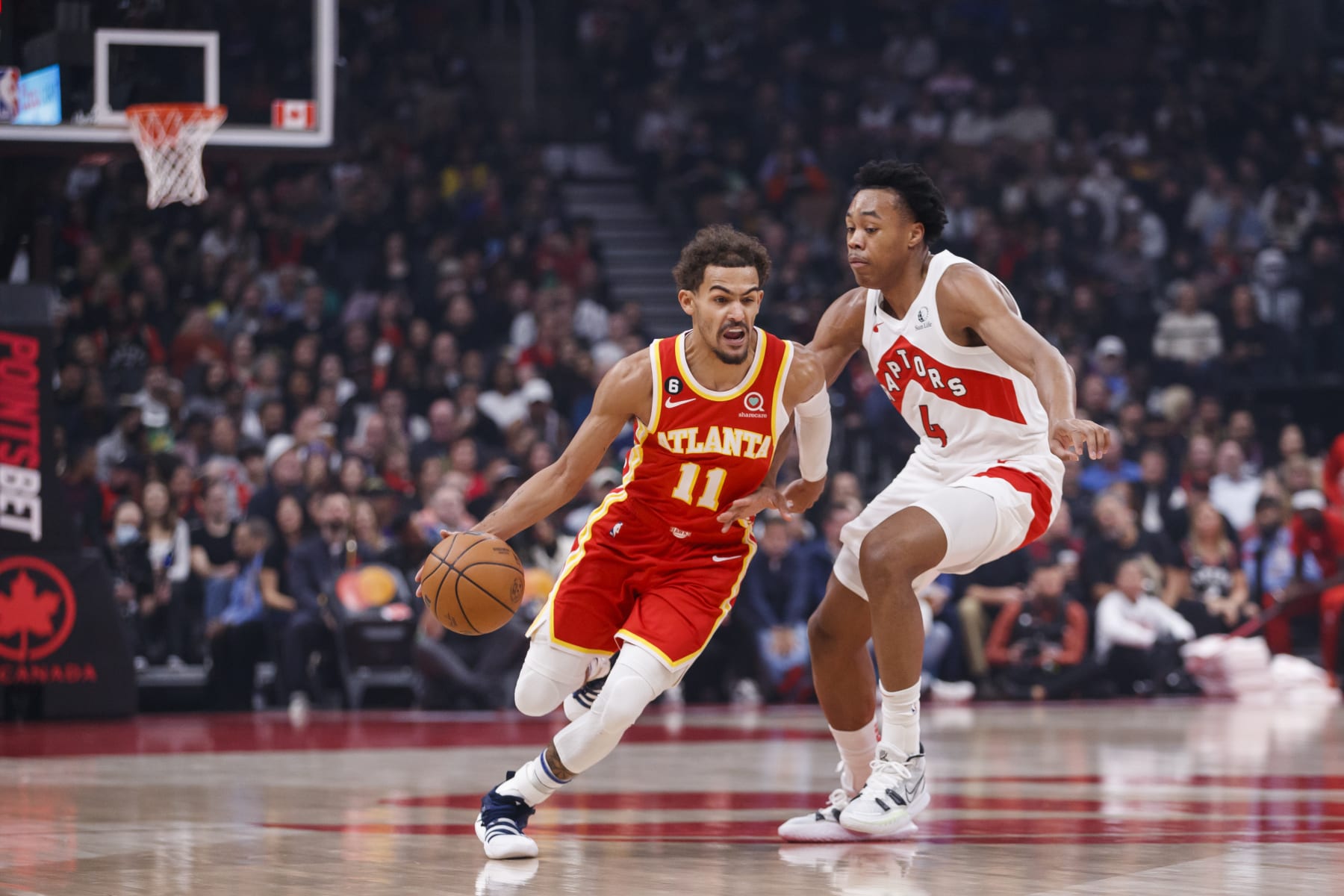 TORONTO, ON - OCTOBER 31: Trae Young #11 of the Atlanta Hawks drives around Scottie Barnes #4 of the Toronto Raptors at Scotiabank Arena on October 31, 2022 in Toronto, Canada. NOTE TO USER: User expressly acknowledges and agrees that, by downloading and or using this photograph, User is consenting to the terms and conditions of the Getty Images License Agreement. (Photo by Cole Burston/Getty Images