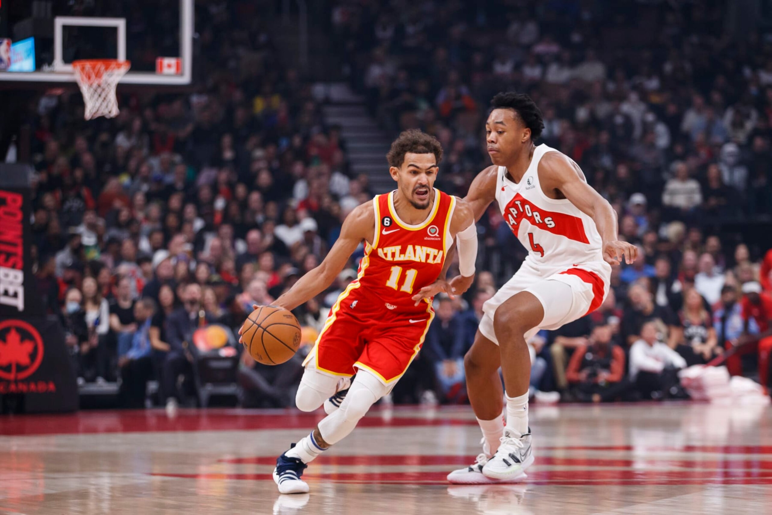 TORONTO, ON - OCTOBER 31: Trae Young #11 of the Atlanta Hawks drives around Scottie Barnes #4 of the Toronto Raptors at Scotiabank Arena on October 31, 2022 in Toronto, Canada. NOTE TO USER: User expressly acknowledges and agrees that, by downloading and or using this photograph, User is consenting to the terms and conditions of the Getty Images License Agreement. (Photo by Cole Burston/Getty Images