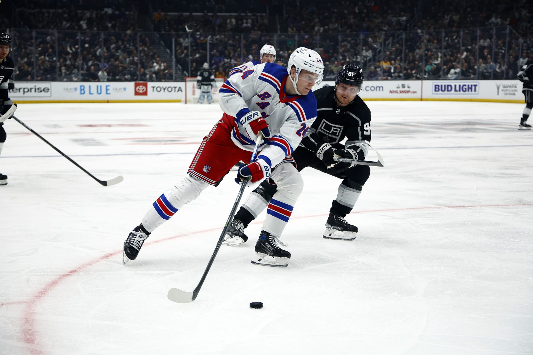 LOS ANGELES, CALIFORNIA - NOVEMBER 22:  Kaapo Kakko #24 of the New York Rangers skates the puck against Carl Grundstrom #91 of the Los Angeles Kings in the second period at Crypto.com Arena on November 22, 2022 in Los Angeles, California. (Photo by Ronald Martinez/Getty Images)