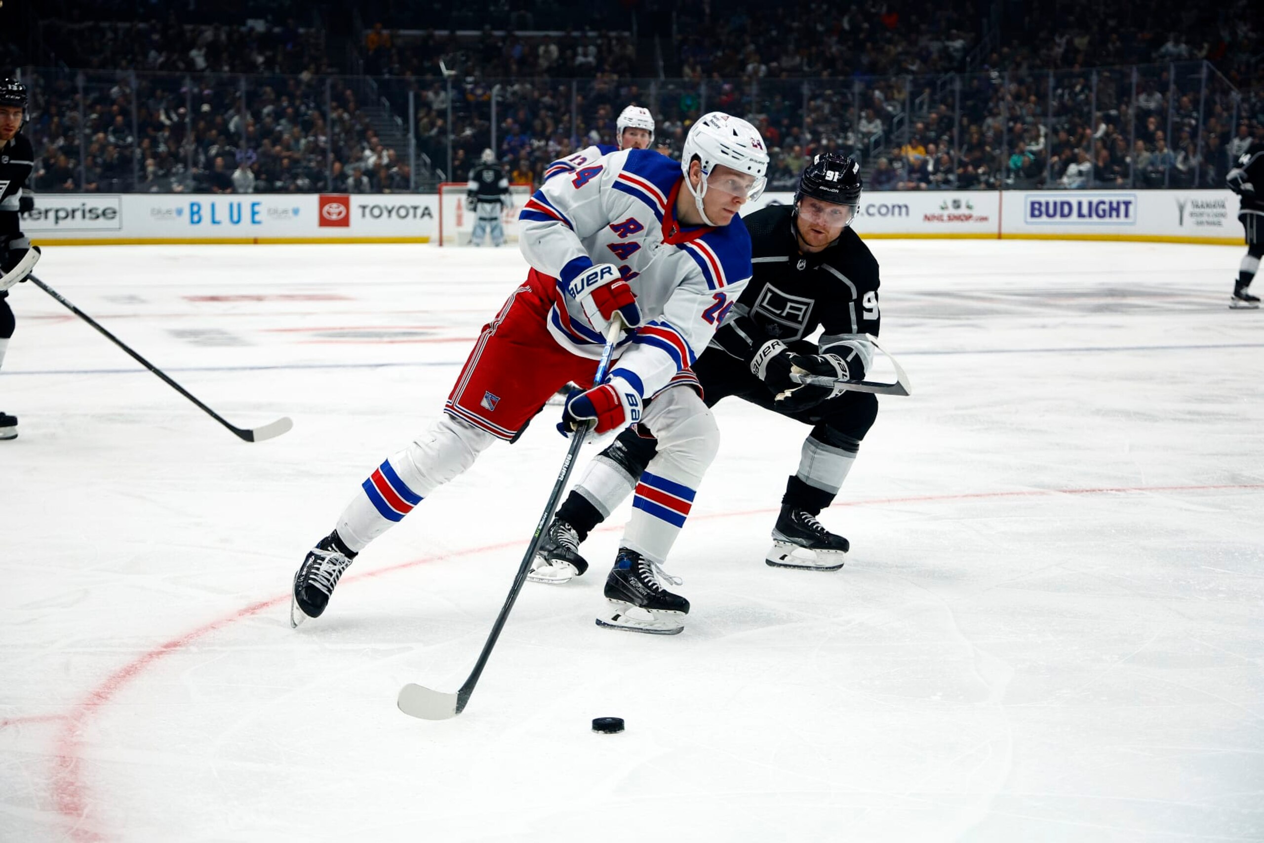 LOS ANGELES, CALIFORNIA - NOVEMBER 22:  Kaapo Kakko #24 of the New York Rangers skates the puck against Carl Grundstrom #91 of the Los Angeles Kings in the second period at Crypto.com Arena on November 22, 2022 in Los Angeles, California. (Photo by Ronald Martinez/Getty Images)