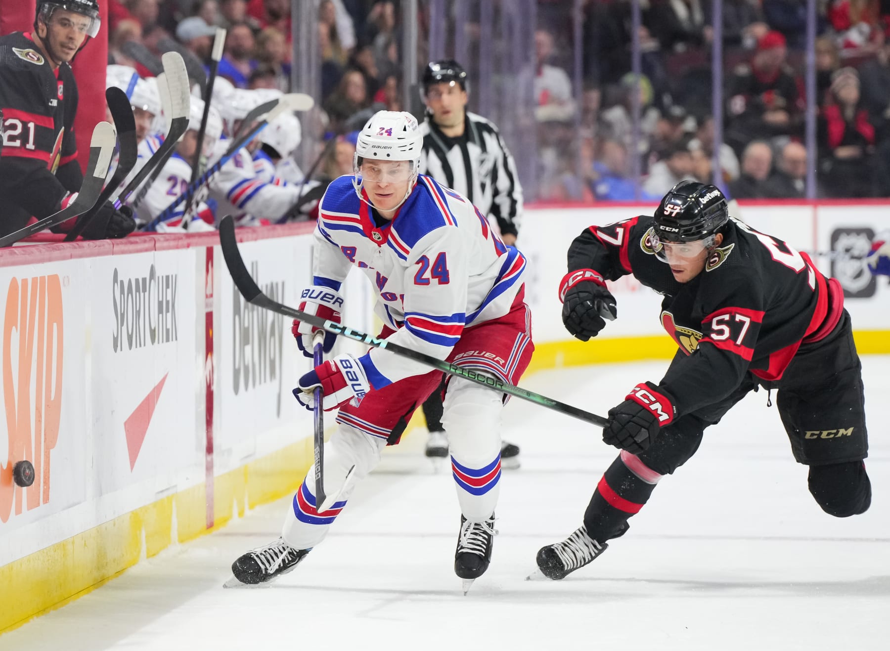 OTTAWA, CANADA - JANUARY 27: Kaapo Kakko #24 of the New York Rangers and Shane Pinto #57 of the Ottawa Senators battle for the puck during the first period at Canadian Tire Centre on January 27, 2024 in Ottawa, Ontario, Canada. (Photo by Chris Tanouye/Freestyle Photography/Getty Images)