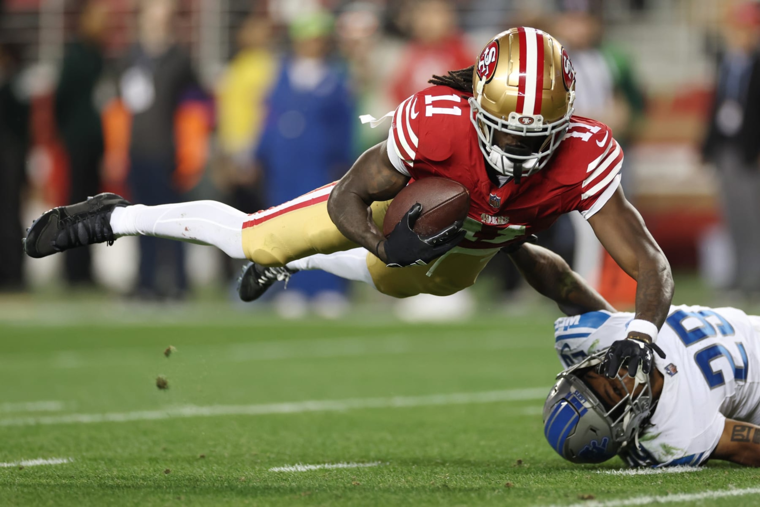 SANTA CLARA, CALIFORNIA - JANUARY 28: Brandon Aiyuk #11 of the San Francisco 49ers catches a pass that was tipped by Kindle Vildor #29 of the Detroit Lions during the third quarter in the NFC Championship Game at Levi's Stadium on January 28, 2024 in Santa Clara, California. (Photo by Ezra Shaw/Getty Images) SANTA CLARA, CALIFORNIA - JANUARY 28: Brandon Aiyuk #11 of the San Francisco 49ers catches a pass that was tipped by Kindle Vildor #29 of the Detroit Lions during the third quarter in the NFC Championship Game at Levi's Stadium on January 28, 2024 in Santa Clara, California. (Photo by Ezra Shaw/Getty Images)