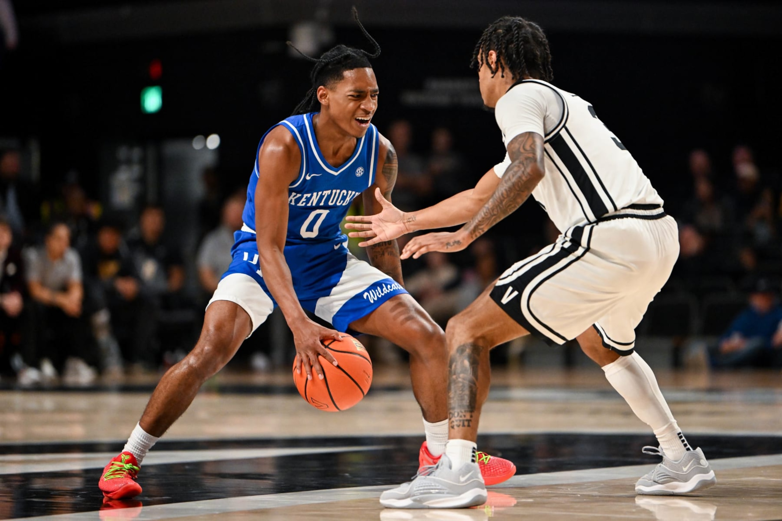 NASHVILLE, TENNESSEE - FEBRUARY 6: Rob Dillingham #0 of the Kentucky Wildcats dribbles the ball agains Paul Lewis #3 of the Vanderbilt Commodores at Memorial Gymnasium on February 6, 2024 in Nashville, Tennessee. (Photo by Carly Mackler/Getty Images)