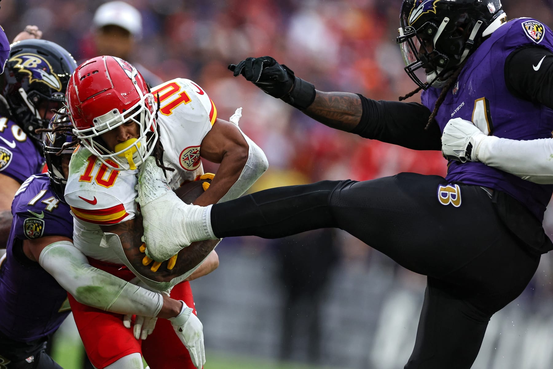 BALTIMORE, MARYLAND - JANUARY 28: Isiah Pacheco #10 of the Kansas City Chiefs is kicked by Jadeveon Clowney #24 of the Baltimore Ravens during the second quarter in the AFC Championship Game at M&T Bank Stadium on January 28, 2024 in Baltimore, Maryland. (Photo by Patrick Smith/Getty Images)