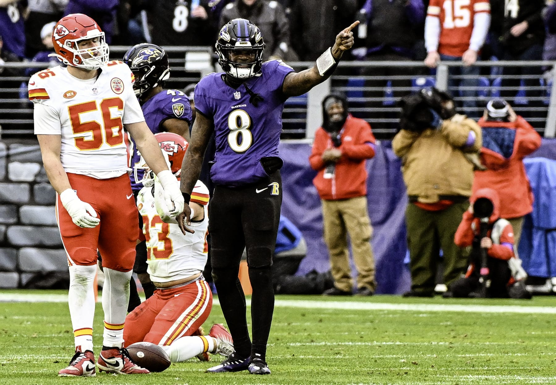 BALTIMORE, MD - JANUARY 28:  Baltimore Ravens quarterback Lamar Jackson (8) signals a first down after catching his own deflected pass as Kansas City Chiefs defensive end George Karlaftis (56) reacts during the Kansas City Chiefs game versus the Baltimore Ravens in the AFC Championship Game on January 28, 2024 at M&T Bank Stadium in Baltimore, MD.  (Photo by Mark Goldman/Icon Sportswire via Getty Images)
