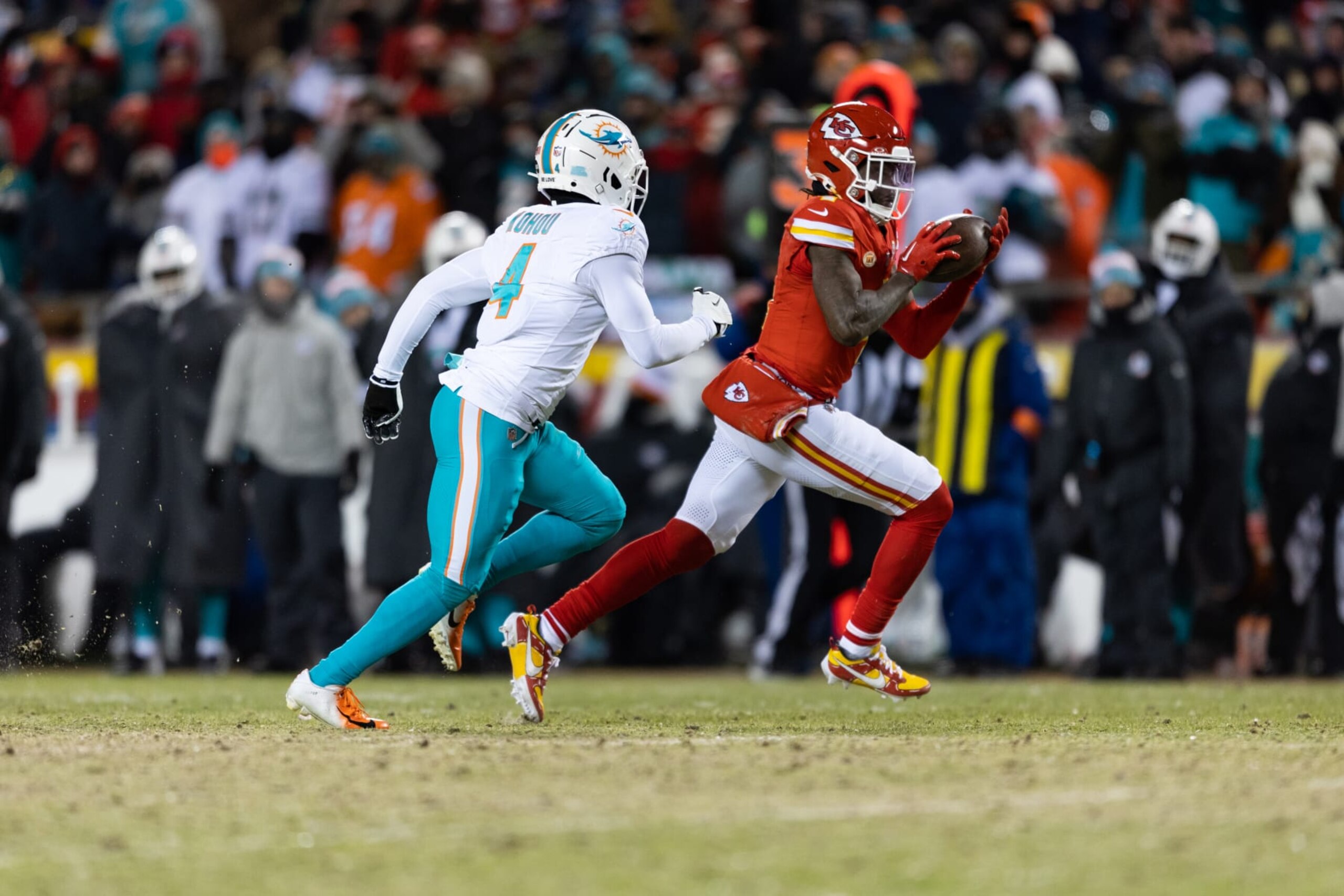 KANSAS CITY, MISSOURI - JANUARY 13: Rashee Rice #4 of the Kansas City Chiefs runs the football as Kader Kohou #4 of the Miami Dolphins defends during an NFL wild-card playoff football game at GEHA Field at Arrowhead Stadium on January 13, 2024 in Kansas City, Missouri. (Photo by Kara Durrette/Getty Images)
