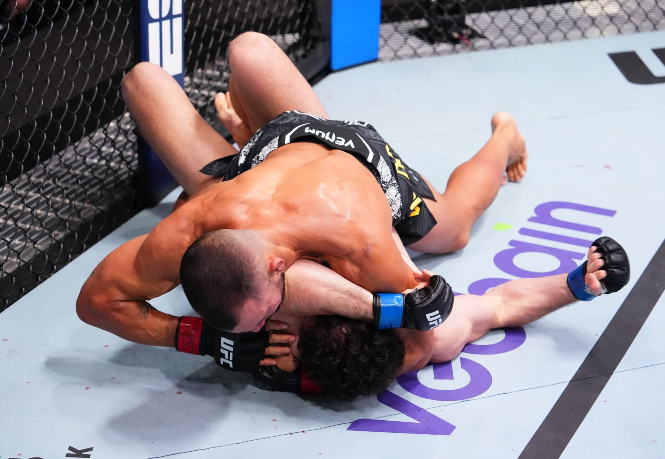 LAS VEGAS, NEVADA - FEBRUARY 10: (L-R) Rodolfo Vieira of Brazil secures a submission against Armen Petrosyan of Russia in a middleweight fight during the UFC Fight Night event at UFC APEX on February 10, 2024 in Las Vegas, Nevada. (Photo by Jeff Bottari/Zuffa LLC via Getty Images)