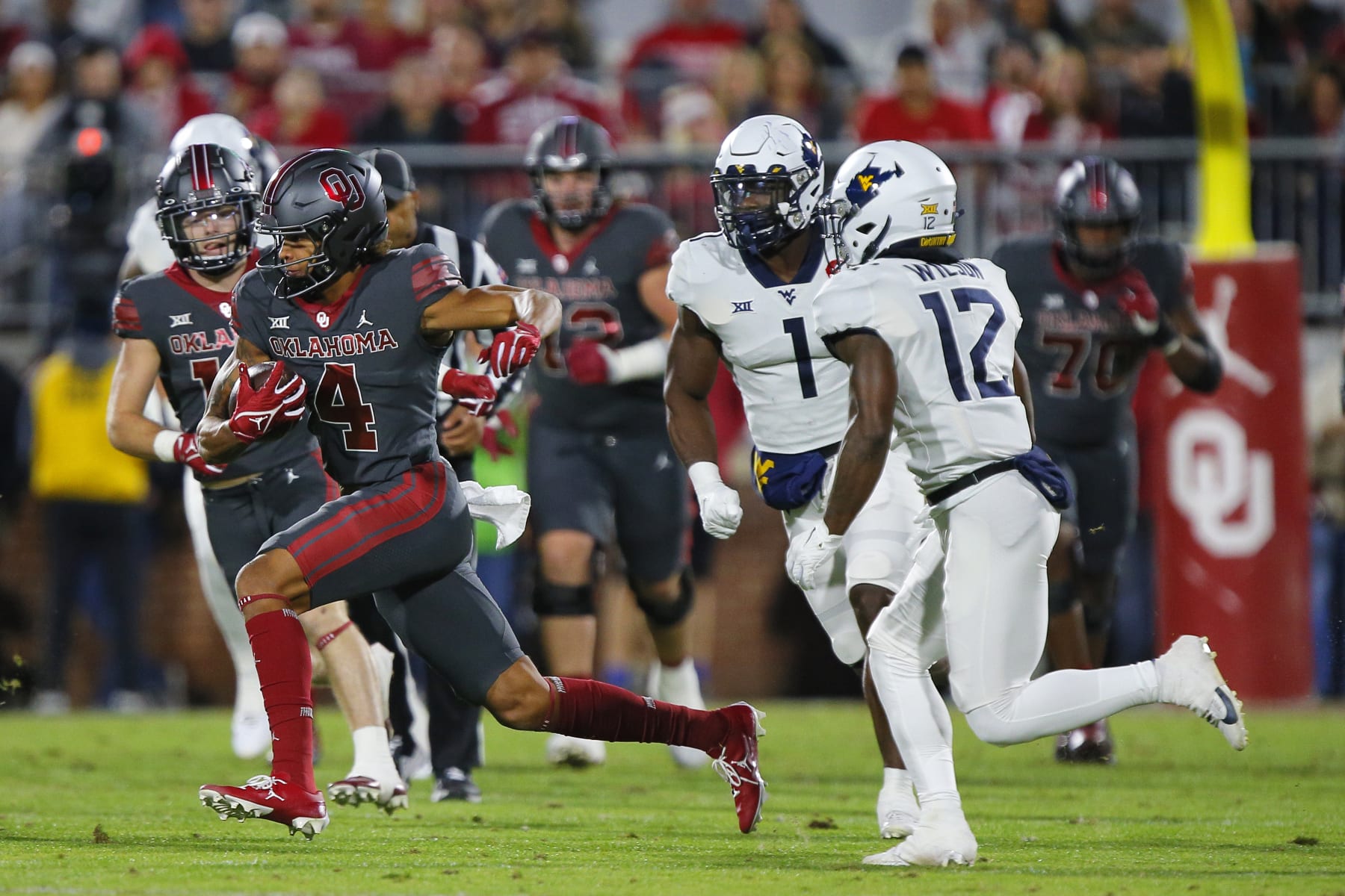 NORMAN, OKLAHOMA - NOVEMBER 11:  Wide receiver Nic Anderson #4 of the Oklahoma Sooners makes a catch for a 19-yard gain against safety Anthony Wilson #12 of the West Virginia Mountaineers in the first quarter at Gaylord Family Oklahoma Memorial Stadium on November 11, 2023 in Norman, Oklahoma. Oklahoma won 59-20. (Photo by Brian Bahr/Getty Images)