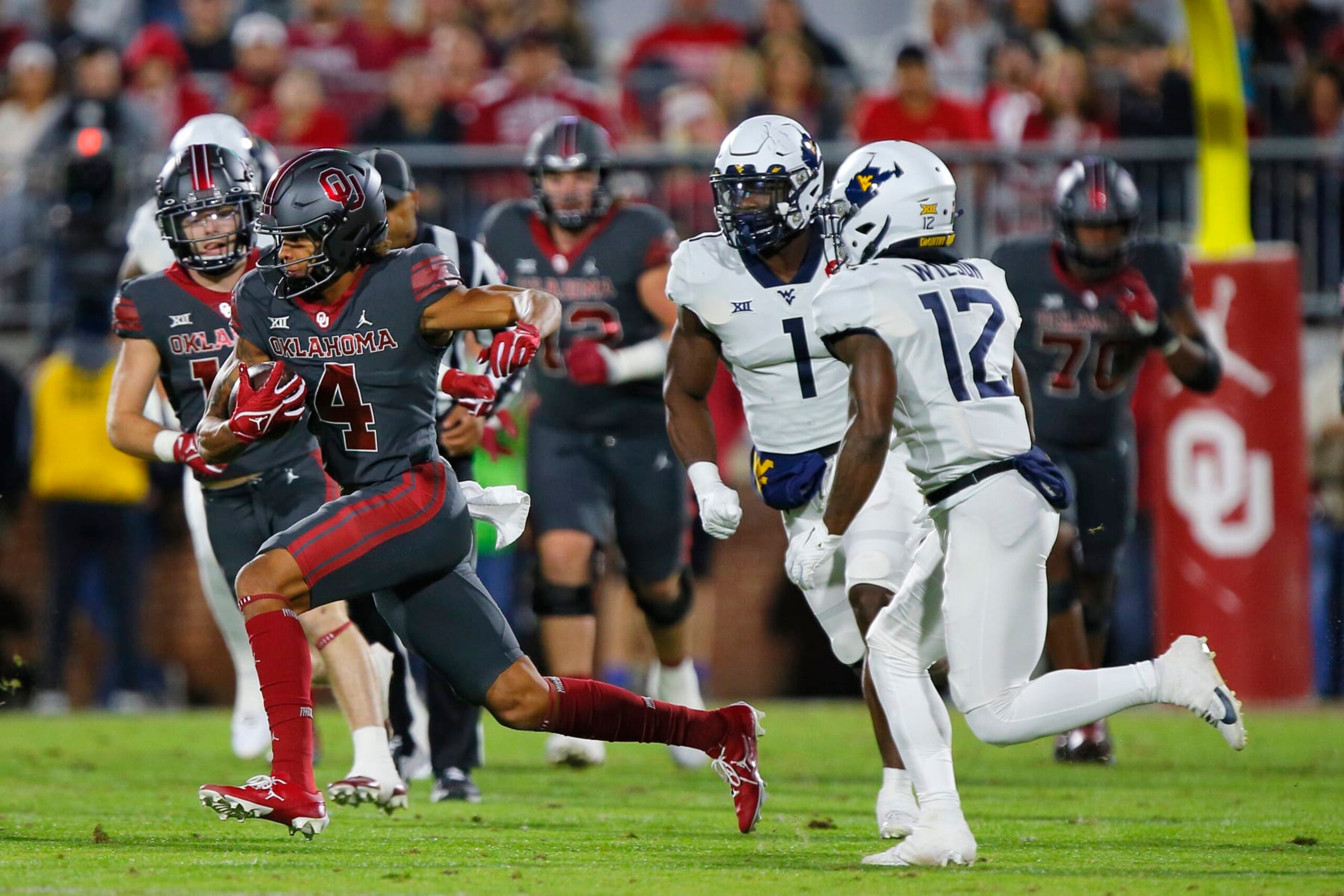 NORMAN, OKLAHOMA - NOVEMBER 11:  Wide receiver Nic Anderson #4 of the Oklahoma Sooners makes a catch for a 19-yard gain against safety Anthony Wilson #12 of the West Virginia Mountaineers in the first quarter at Gaylord Family Oklahoma Memorial Stadium on November 11, 2023 in Norman, Oklahoma. Oklahoma won 59-20. (Photo by Brian Bahr/Getty Images)