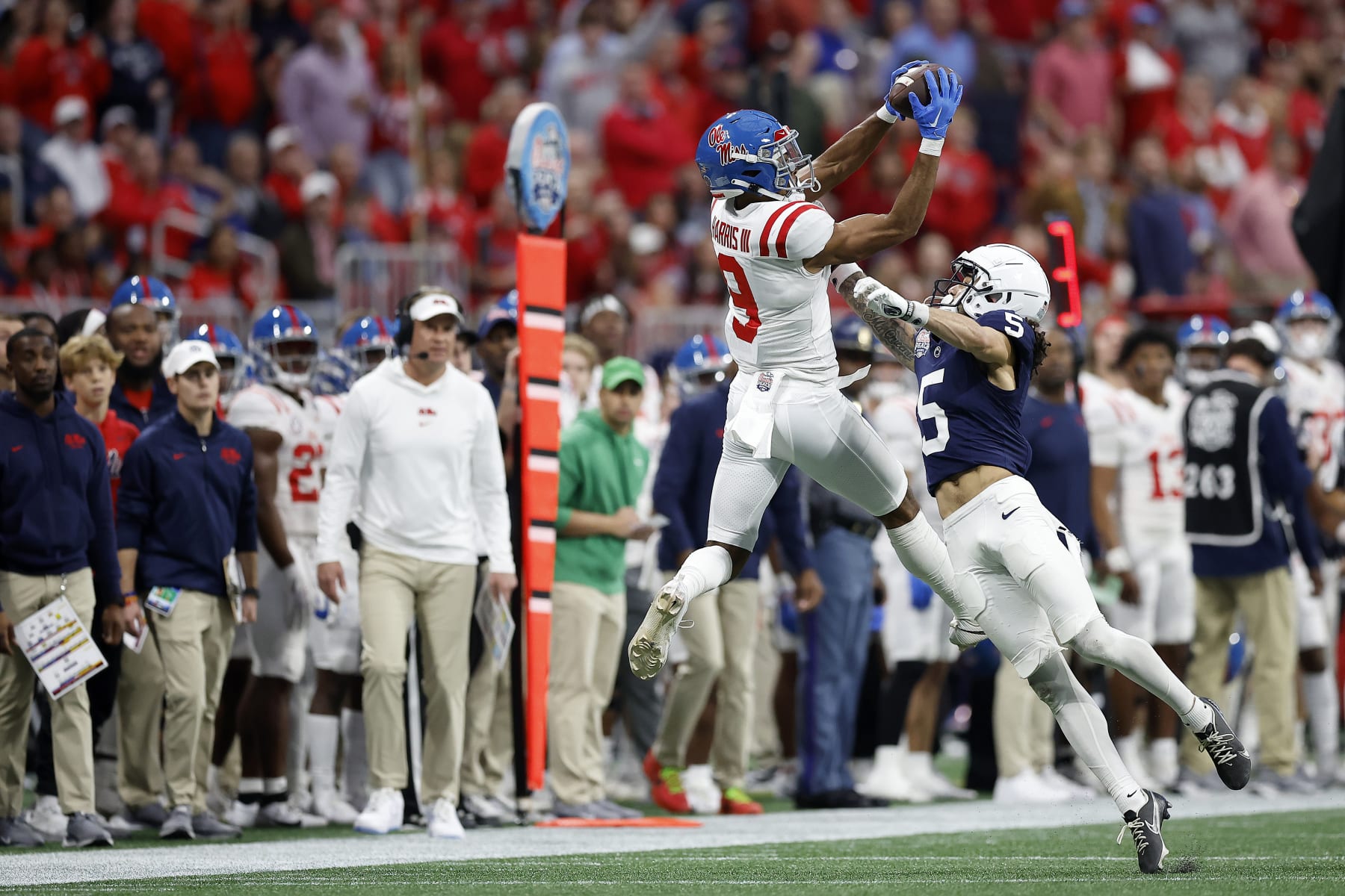 ATLANTA, GEORGIA - DECEMBER 30: Tre Harris #9 of the Mississippi Rebels catches a pass, which was later ruled incomplete, as Cam Miller #5 of the Penn State Nittany Lions pressures during the second quarter in the Chick-fil-A Peach Bowl at Mercedes-Benz Stadium on December 30, 2023 in Atlanta, Georgia. (Photo by Alex Slitz/Getty Images)
