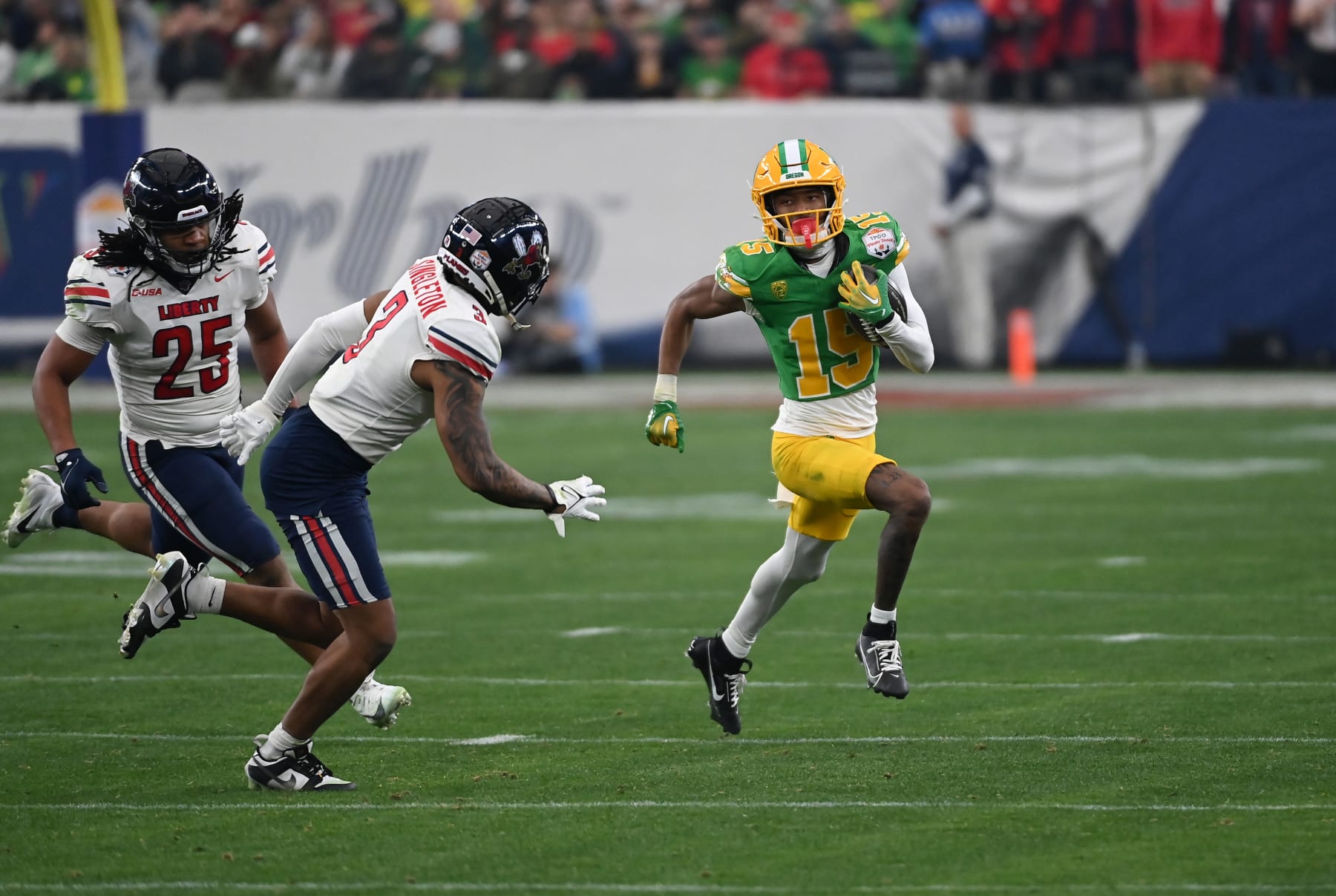 GLENDALE, ARIZONA - JANUARY 01: Tez Johnson #15 of the Oregon Ducks runs with the ball against the Liberty Flames during the 2023 Vrbo Fiesta Bowl at State Farm Stadium on January 01, 2024 in Glendale, Arizona. (Photo by Norm Hall/Getty Images)
